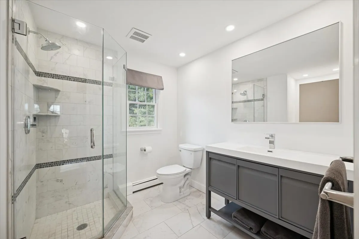 a spacious bedroom with a bed and a window