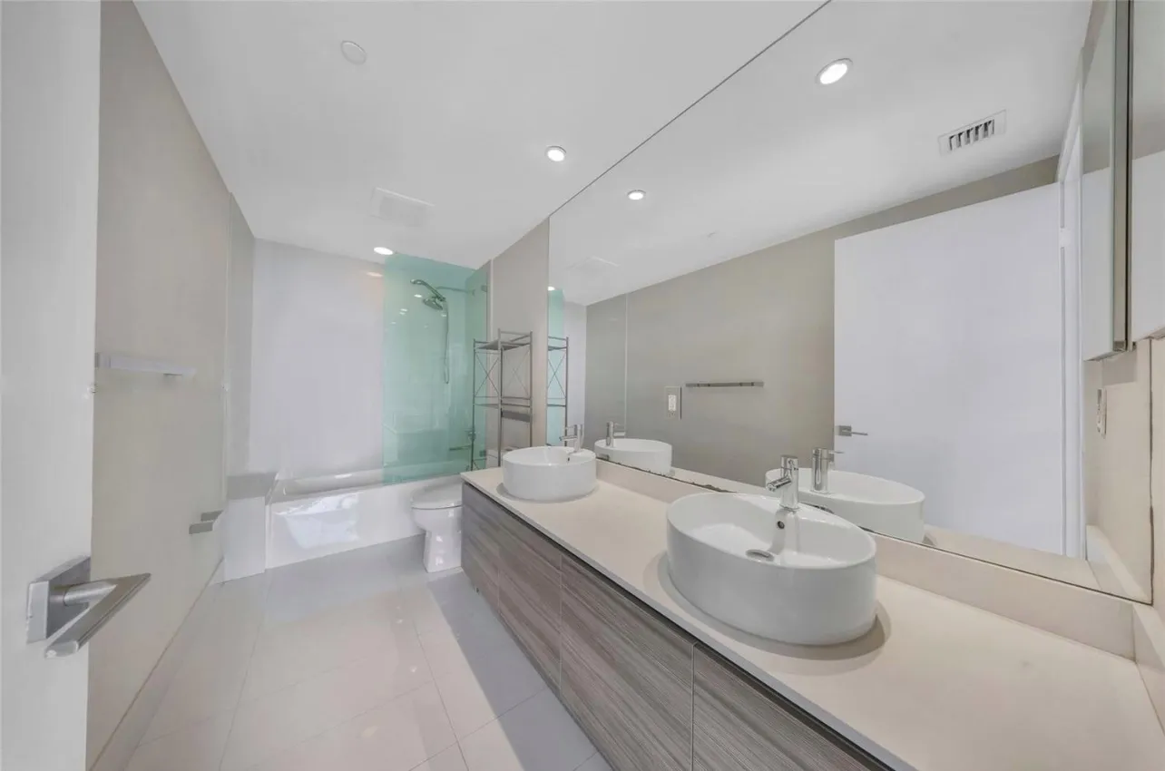 a spacious bathroom with a double vanity sink and a mirror