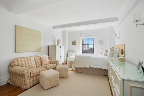 a spacious bedroom with a bed and couch