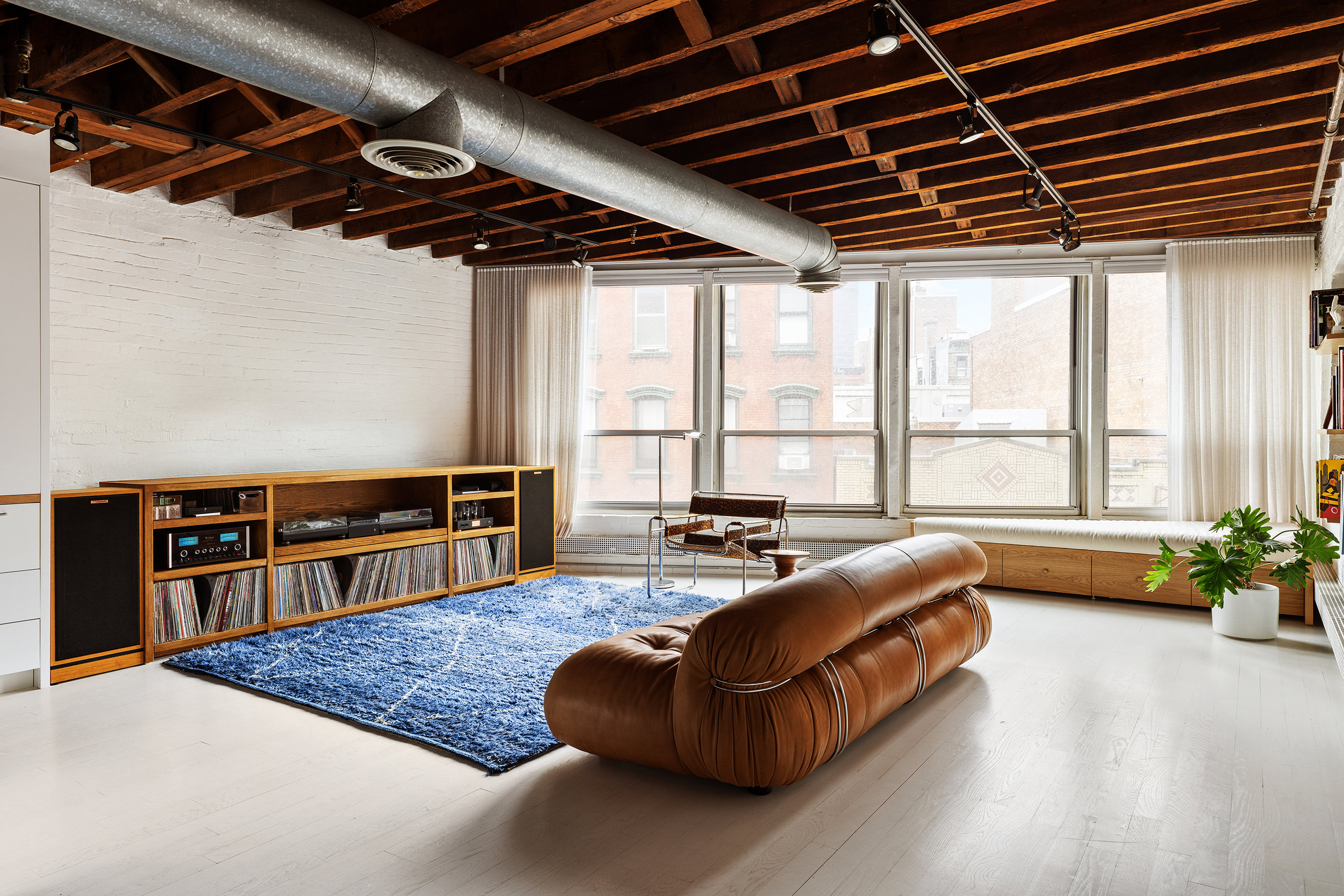 48 Canal Street, Unit 4 Manhattan, NY 10002 - Photo 2 of 13 a living room with furniture and a large window