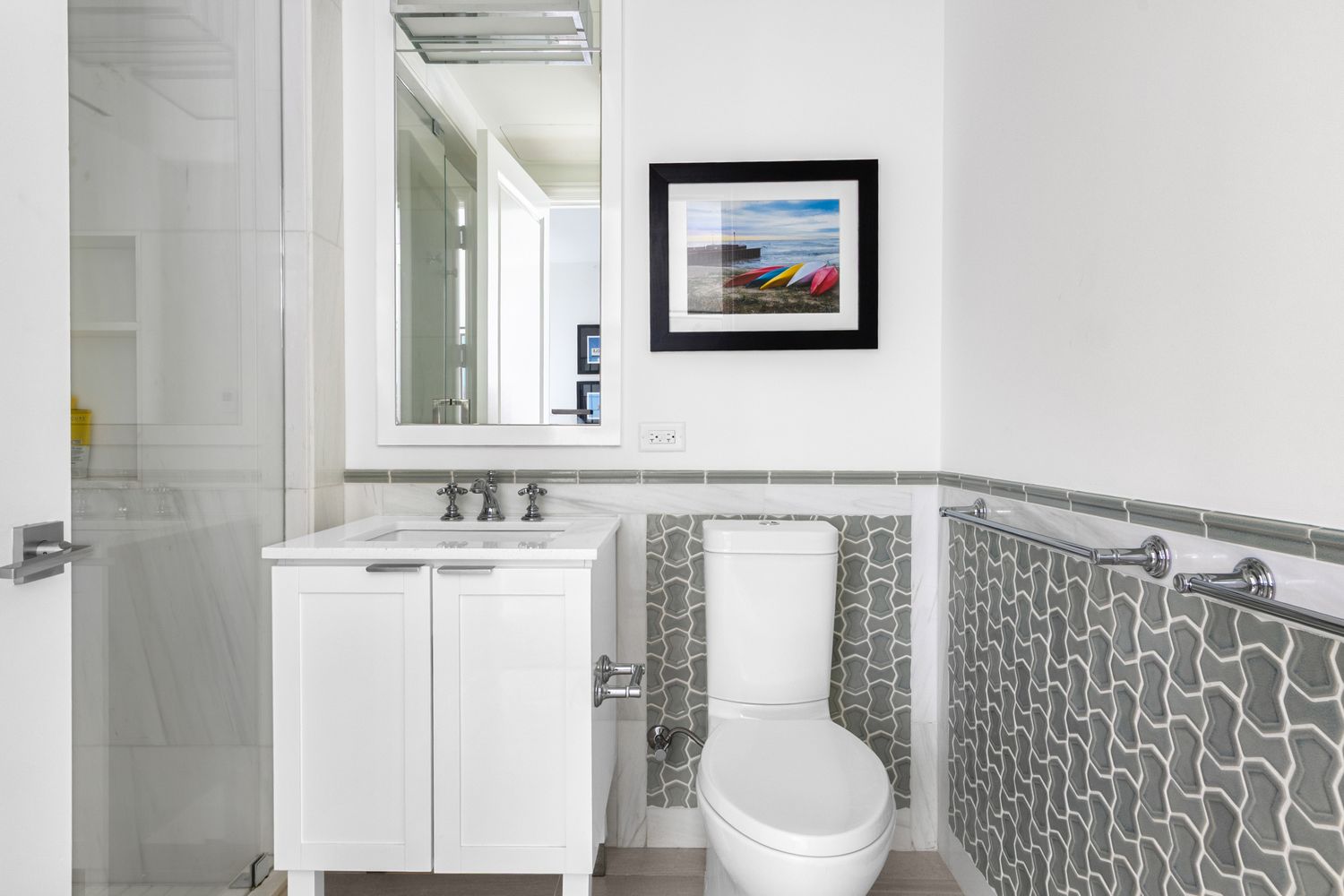 344 West 72nd Street, Unit 1008 Manhattan, NY 10023 - Photo 12 of 35 a bathroom with a toilet a sink and a mirror