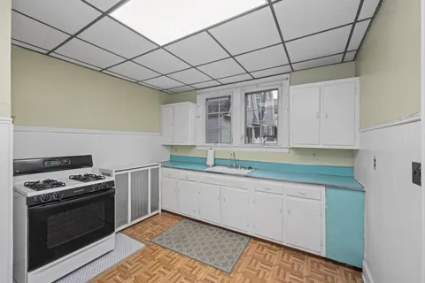 a kitchen with stainless steel appliances a stove sink and cabinets