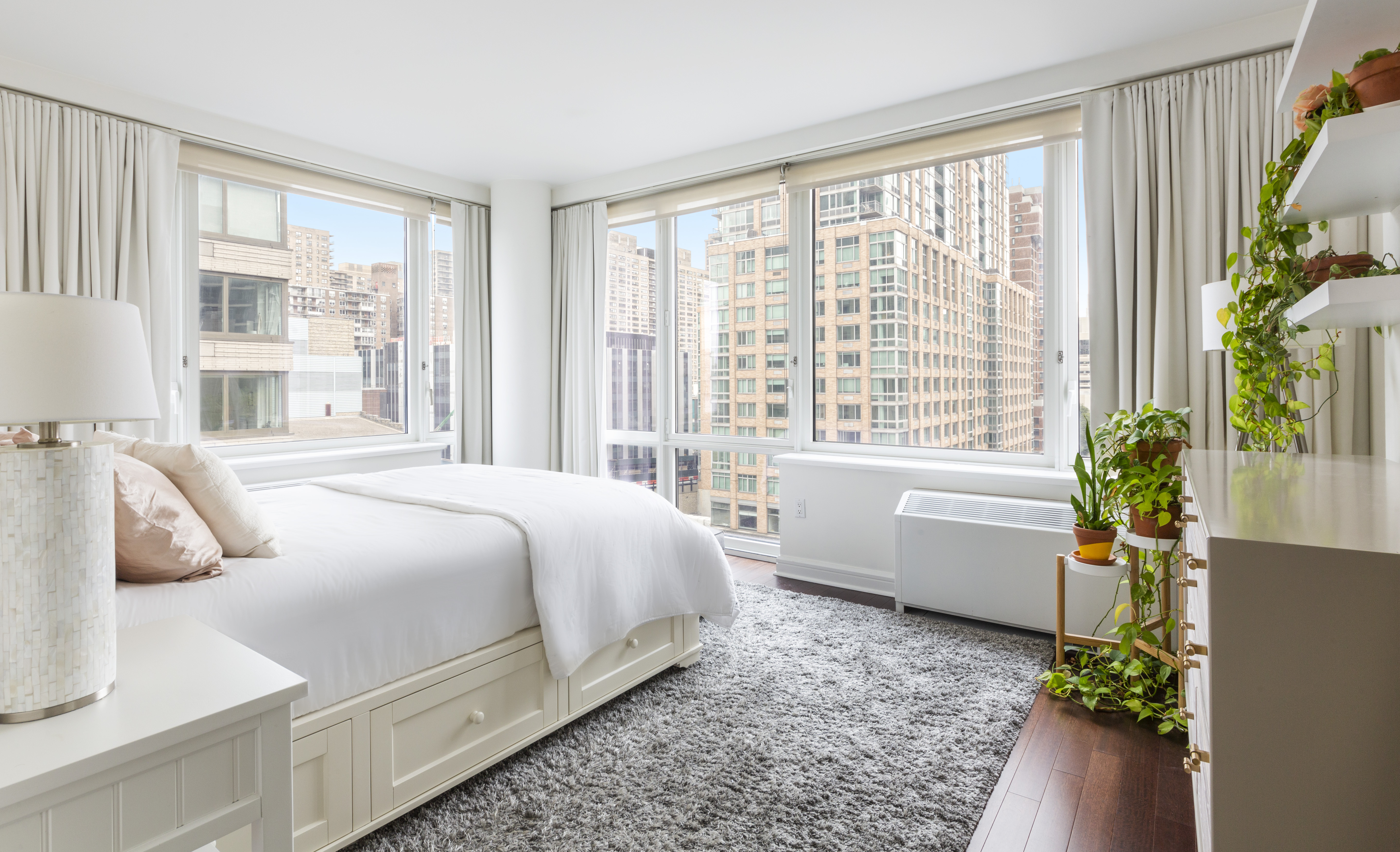 80 Riverside Boulevard, Unit 9E Manhattan, NY 10069 - Photo 7 of 14 a bedroom with bed and a window