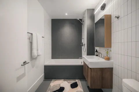 a bathroom with a bathtub a sink and a mirror
