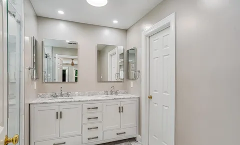 a bathroom with a granite countertop sink mirror and double