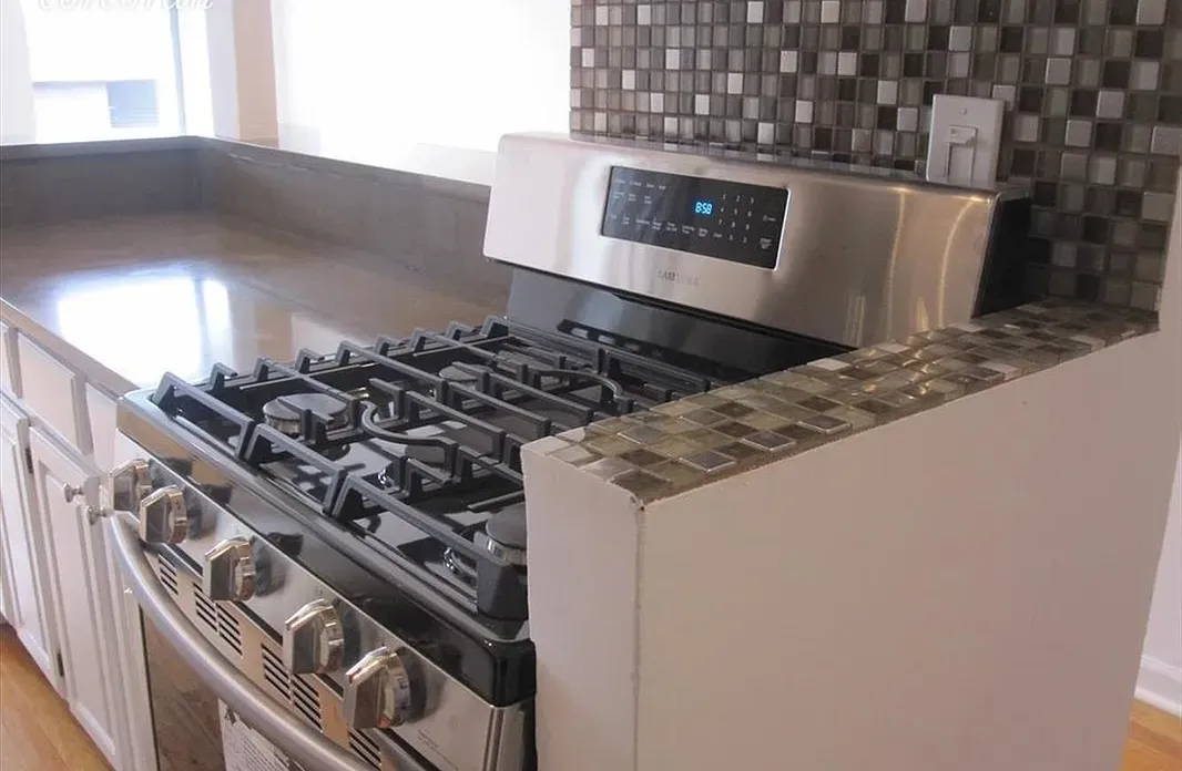 a kitchen with a sink a stove and cabinets