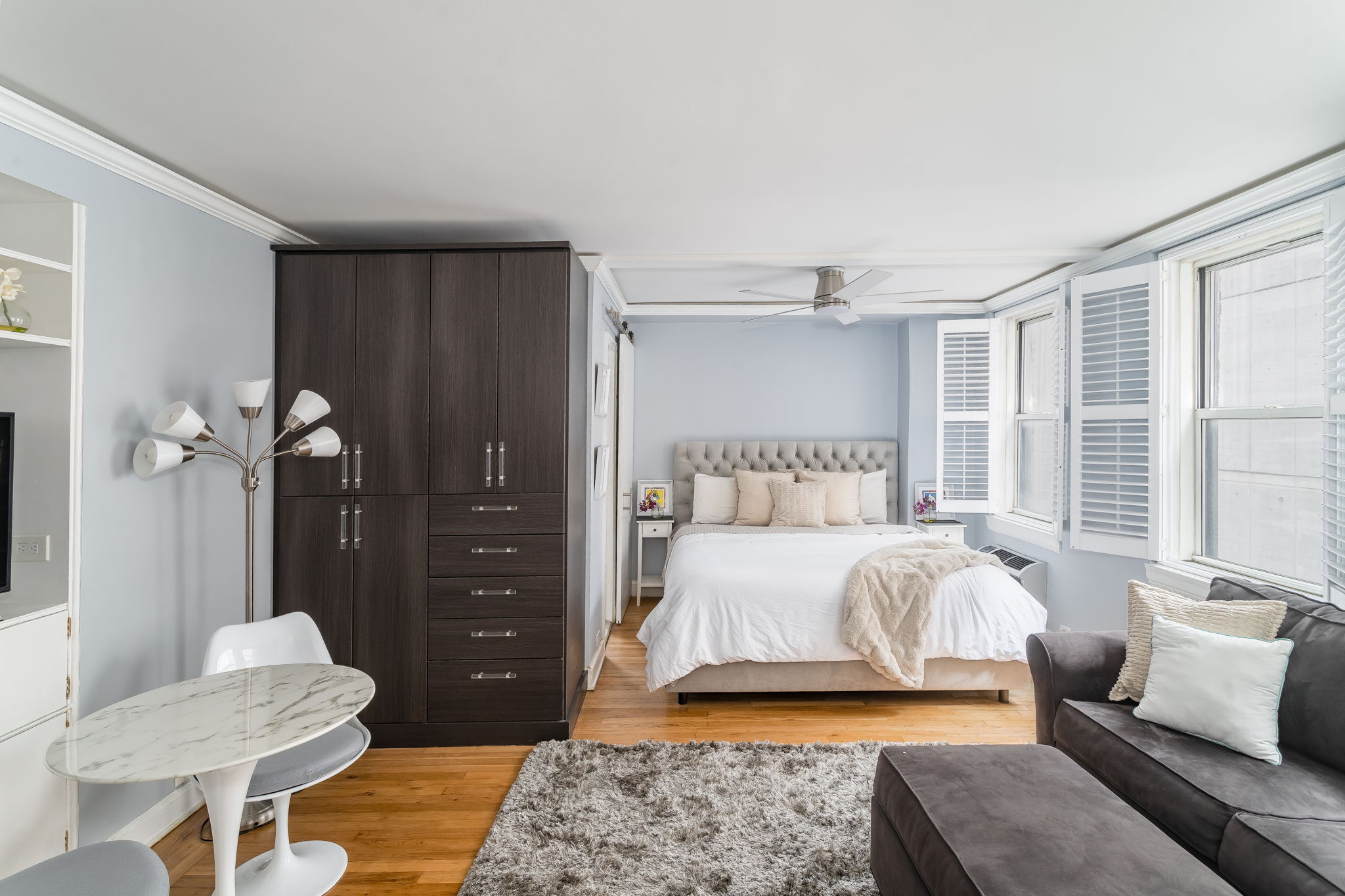 155 East 49th Street, Unit 10E Manhattan, NY 10017 - Photo 5 of 12 a bedroom with a bed and a couch