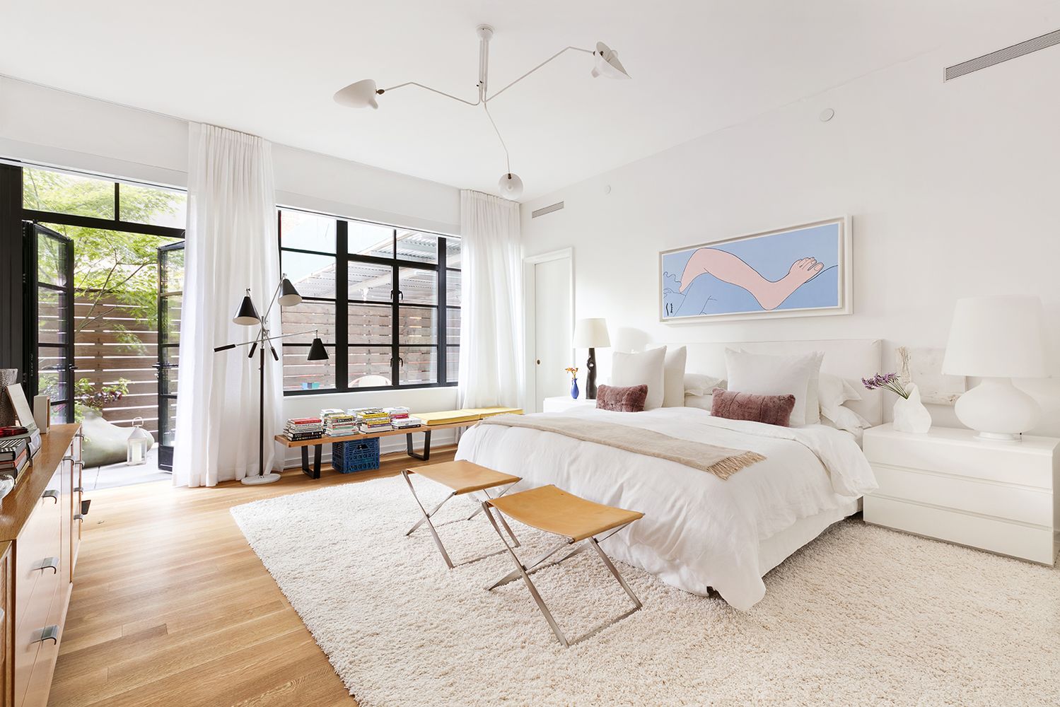 a spacious bedroom with a large bed and a large window