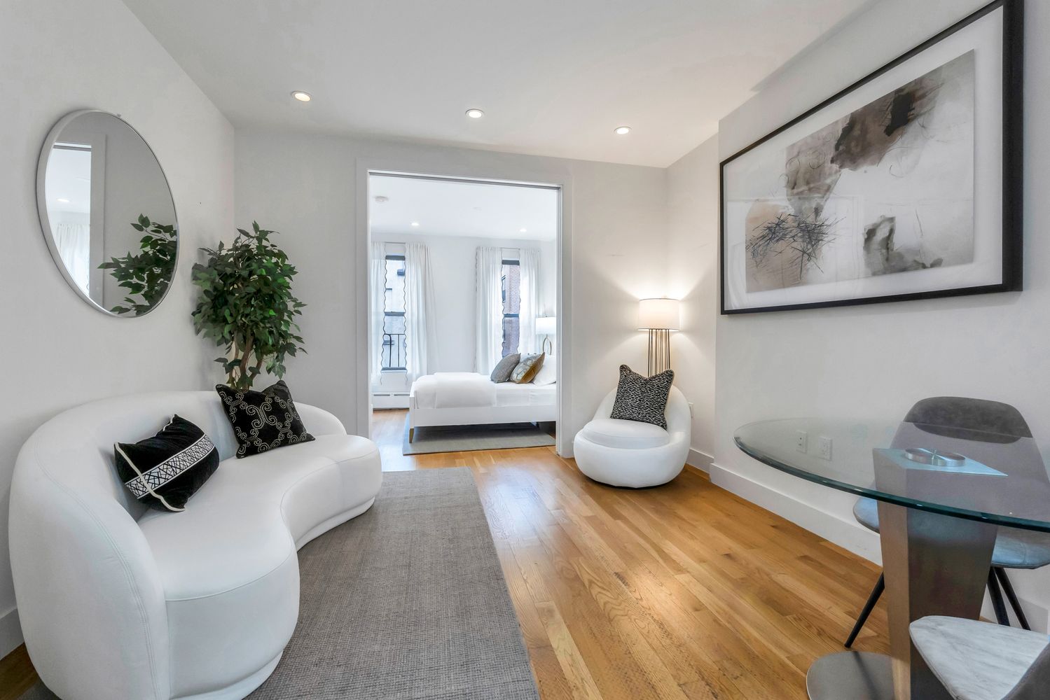 223 West 10th Street, Unit 2C Manhattan, NY 10014 - Photo 1 of 11 a living room with furniture and a large mirror