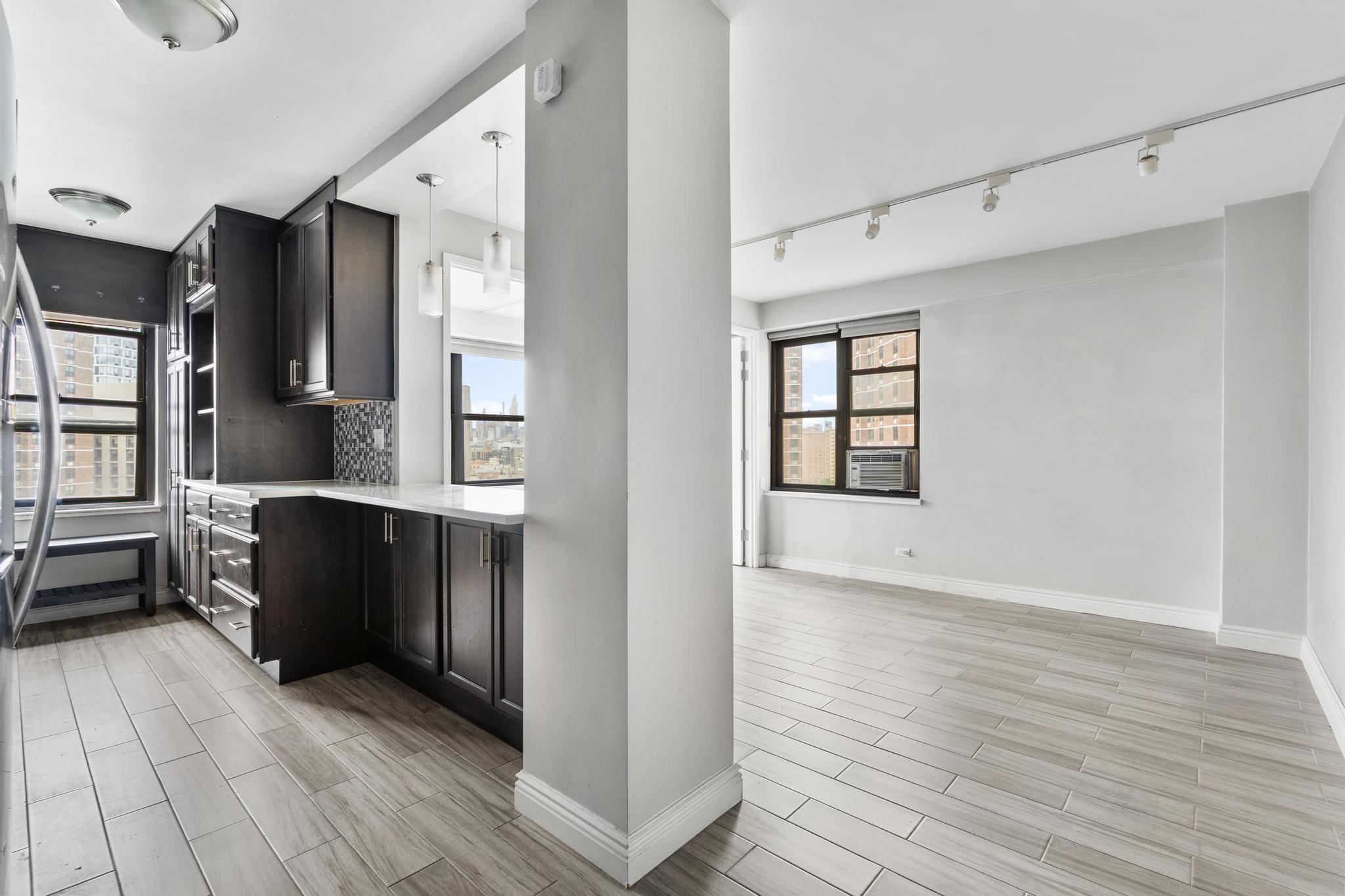 a view of kitchen with furniture and wooden floor