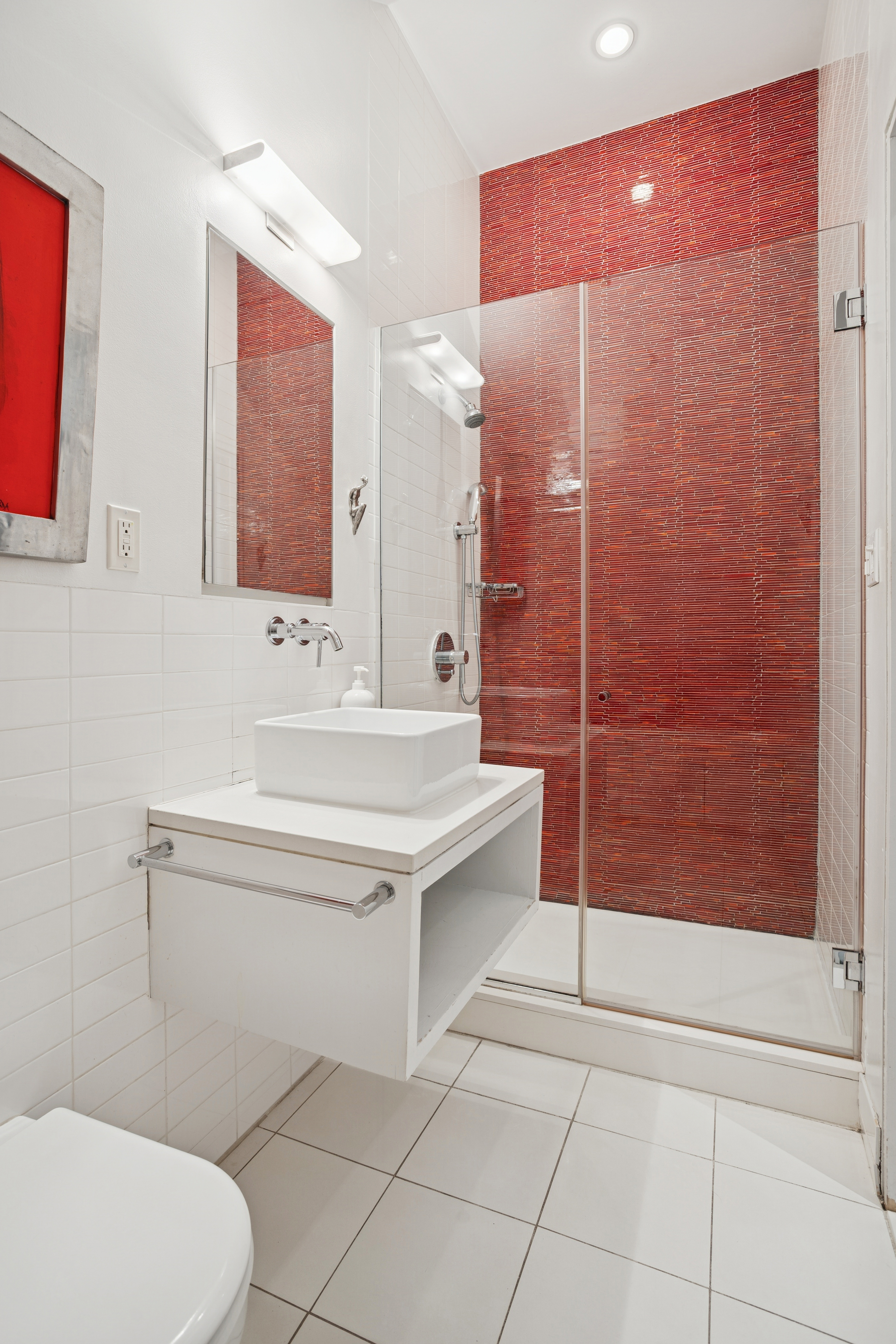 716 Broadway Manhattan, NY 10003 - Photo 13 of 15 a bathroom with a sink a toilet and shower