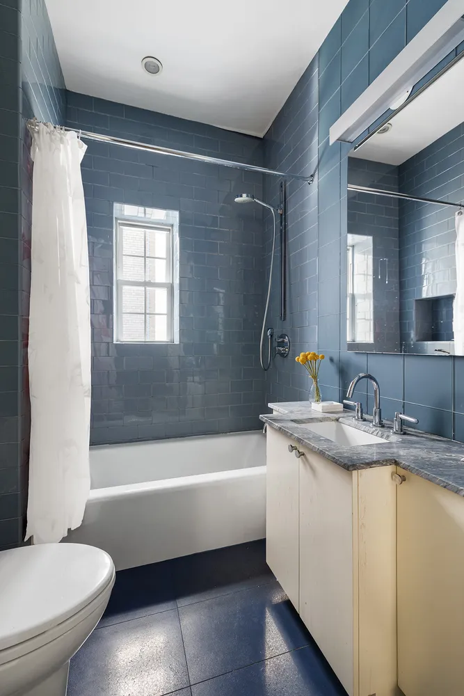 a bathroom with a granite countertop toilet sink and bathtub