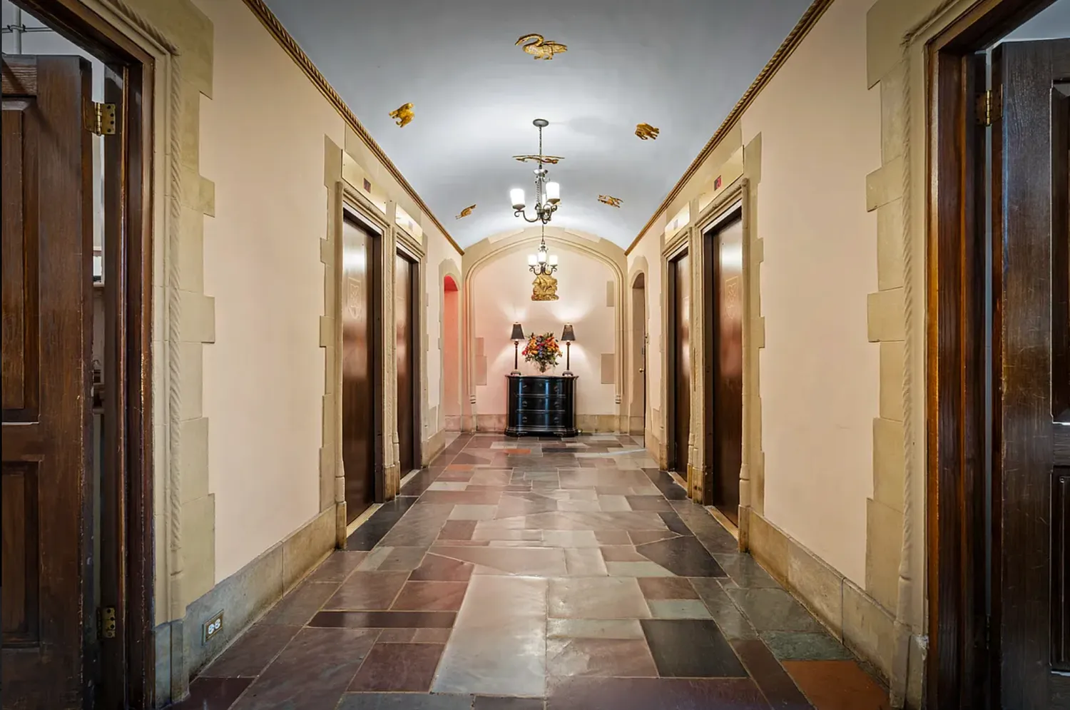 a view of a hallway with wooden shelves
