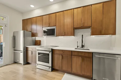 a kitchen with a sink stainless steel appliances and cabinets