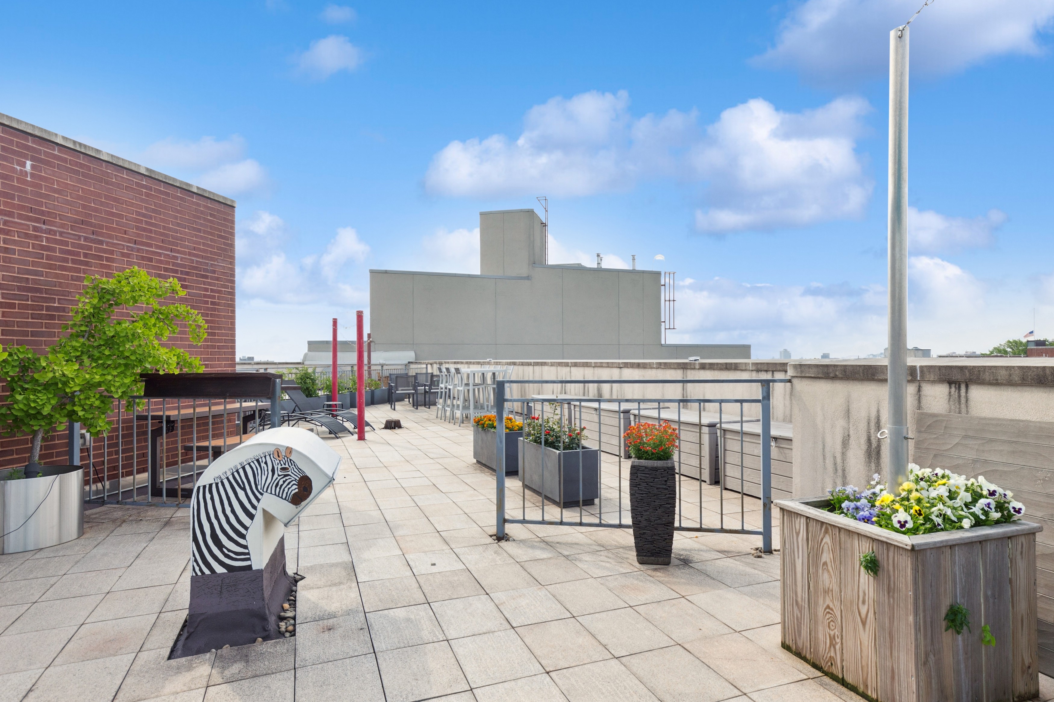 456 West 167th Street, Unit 7C Manhattan, NY 10032 - Photo 14 of 16 a view of roof deck with two chairs and a barbeque