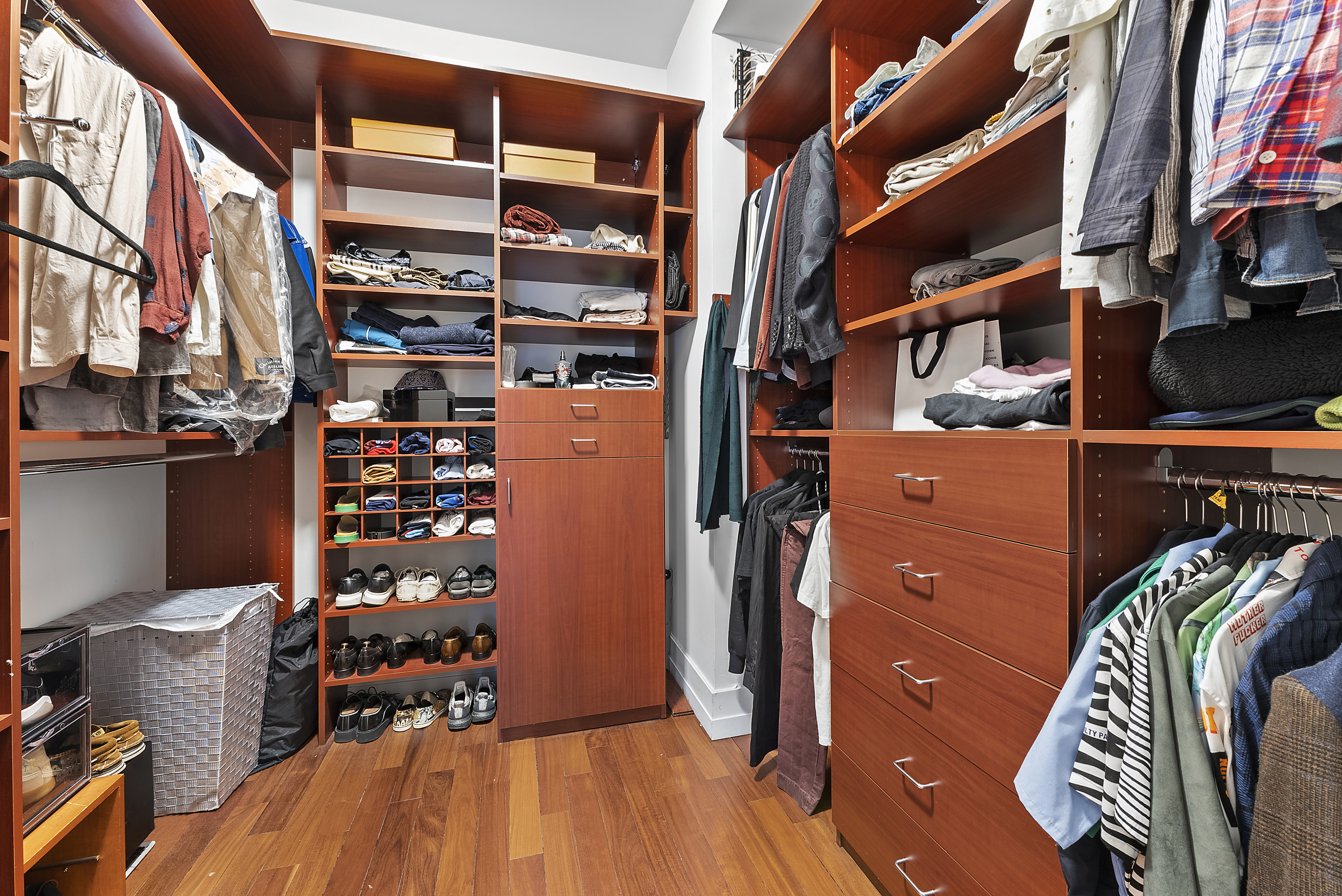 66 Leonard Street, Unit 2A Manhattan, NY 10013 - Photo 8 of 15 a view of walk in closet with clothes and shoes