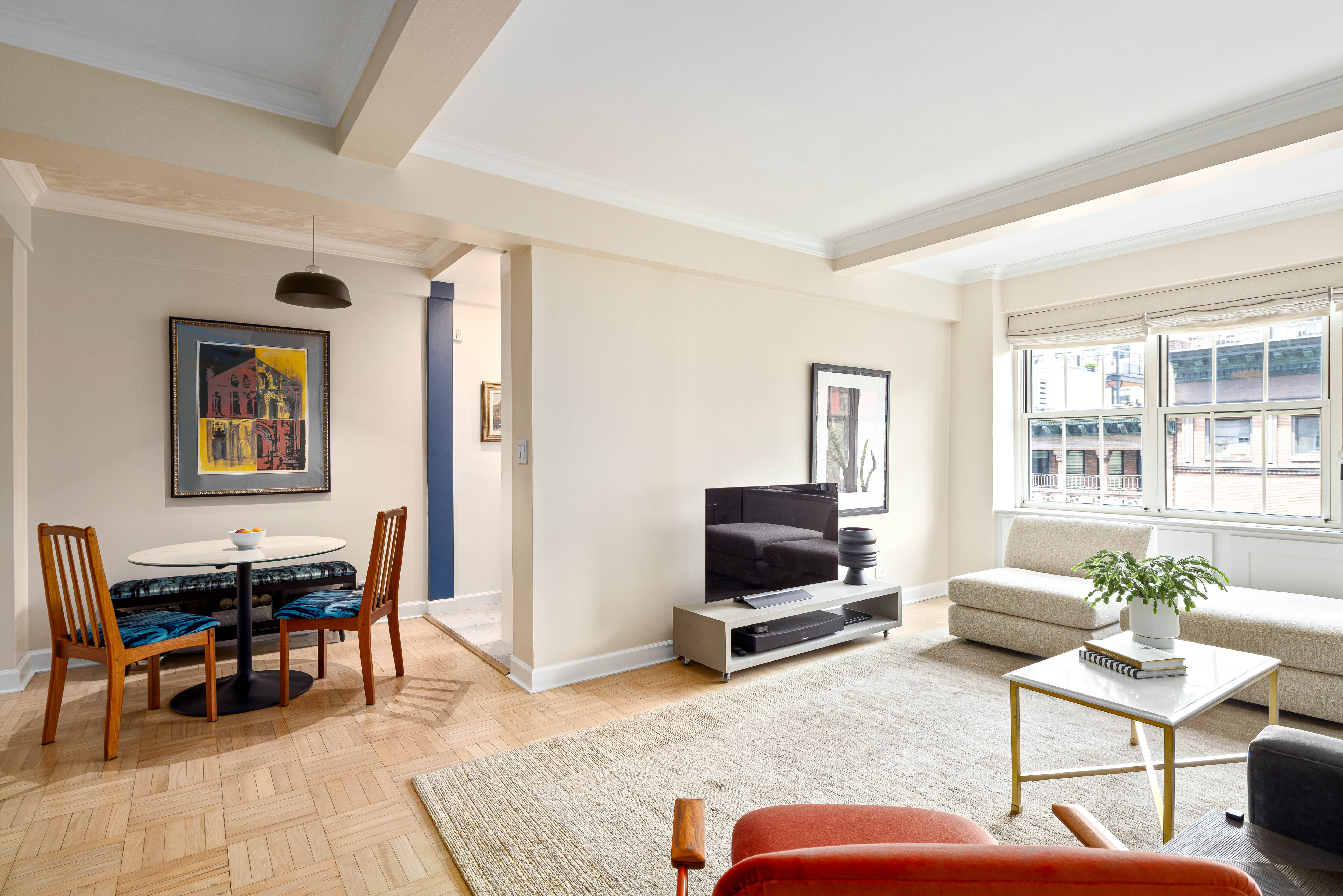 320 West 76th Street, Unit 6D Manhattan, NY 10023 - Photo 2 of 16 a living room with furniture a rug and a flat screen tv