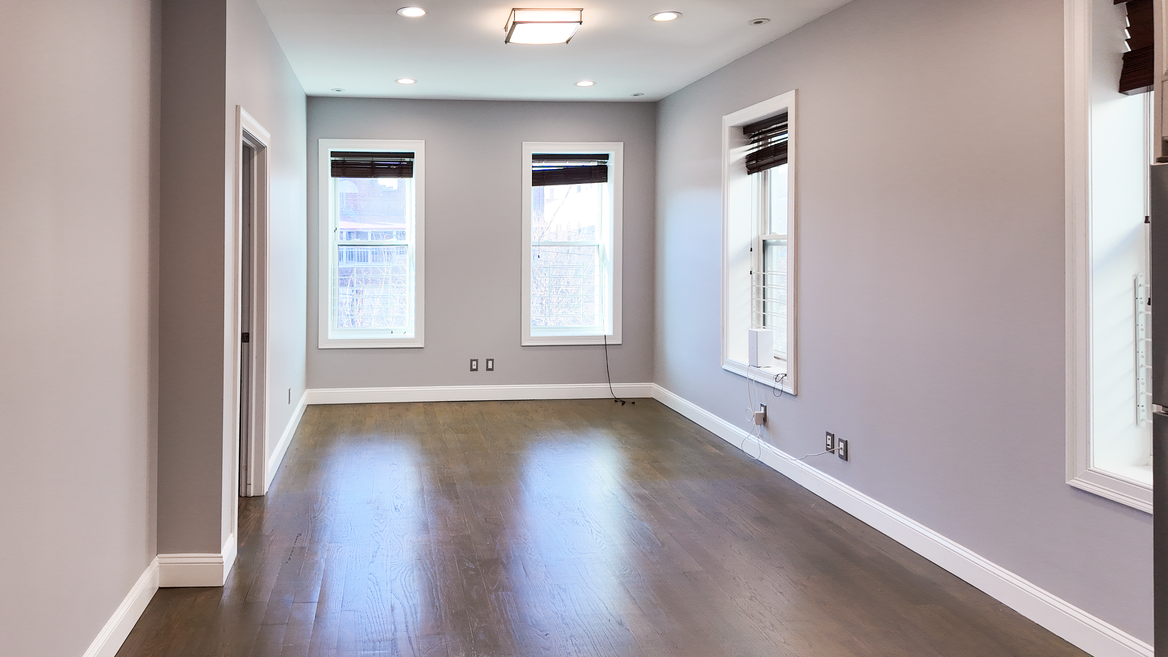 567 New Jersey Avenue, Unit 2 Brooklyn, NY 11207 - Photo 2 of 11 an empty room with wooden floor and windows