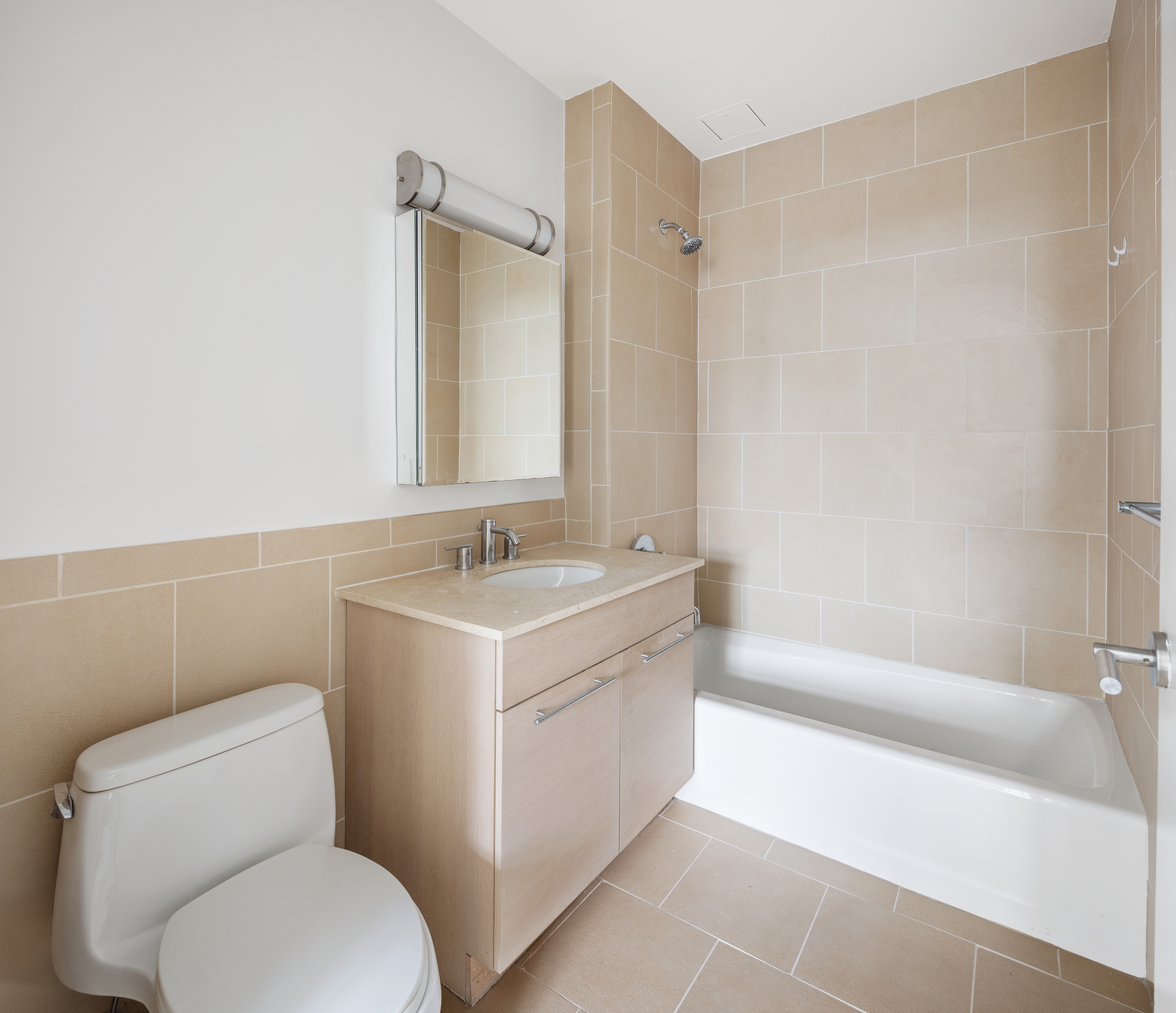 2279 3rd Avenue, Unit 6B Manhattan, NY 10035 - Photo 7 of 10 a bathroom with a sink mirror toilet and bathtub