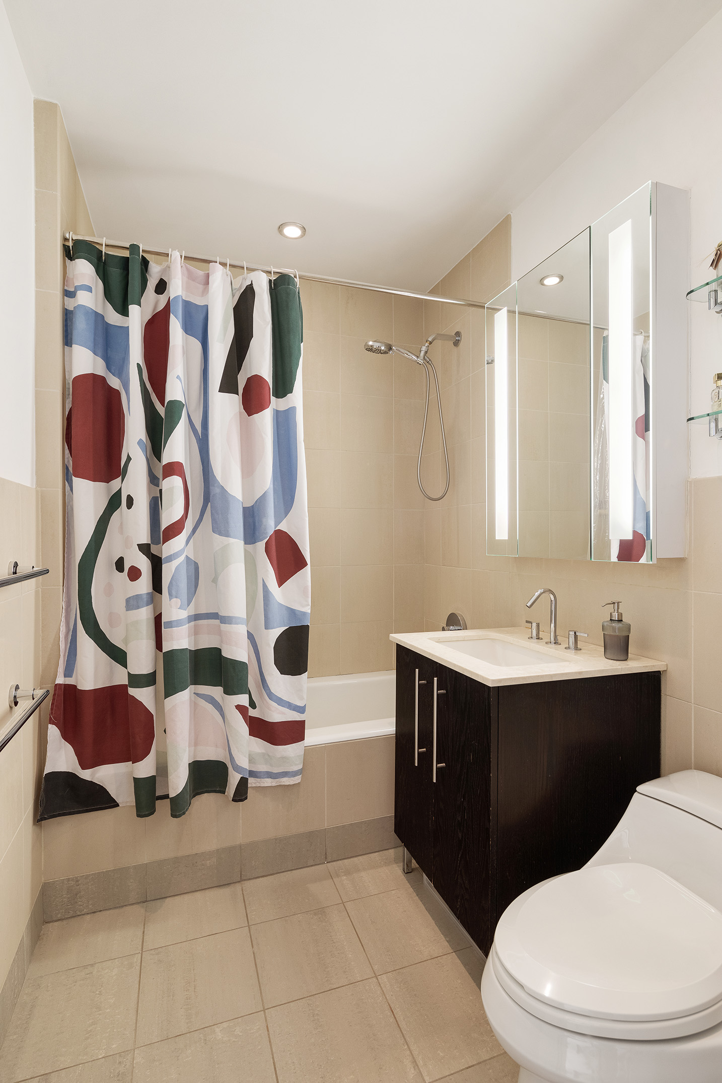 1 Northside Piers, Unit 18C Brooklyn, NY 11249 - Photo 5 of 12 a bathroom with a sink a toilet and shower curtain