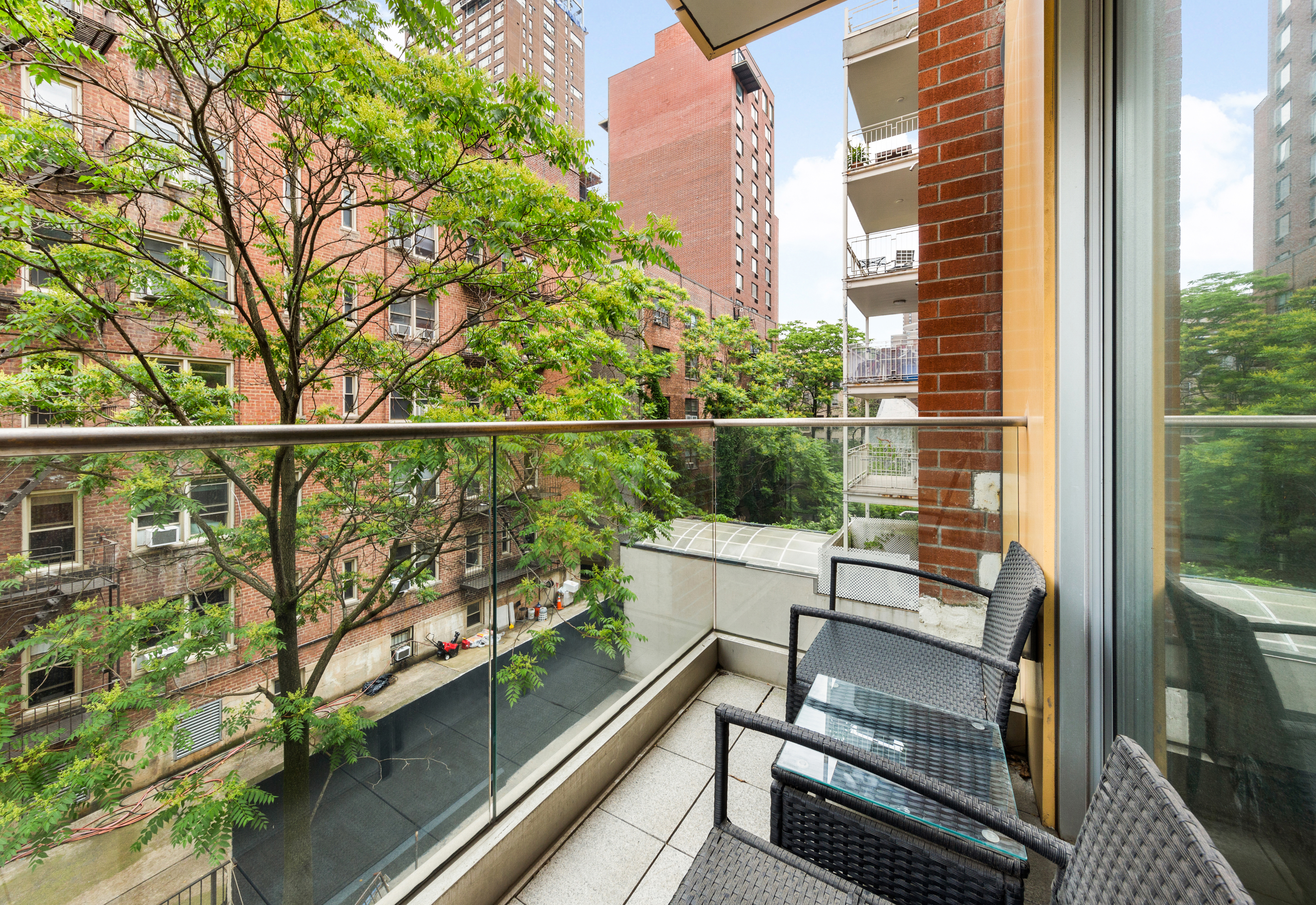 337 East 62nd Street, Unit 3C Manhattan, NY 10065 - Photo 11 of 14 a view of a balcony with wooden floor and outdoor seating