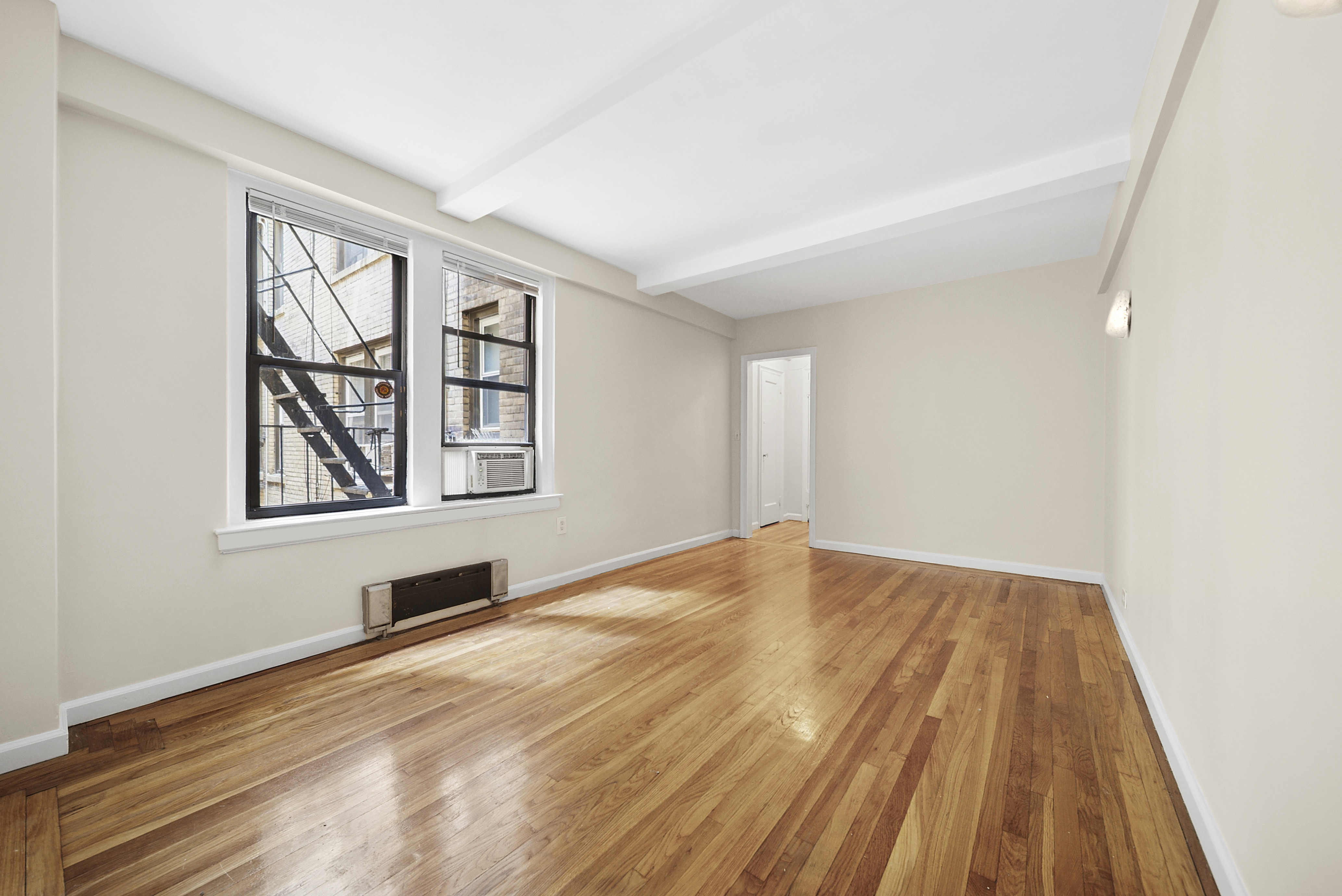 321 East 54th Street, Unit 2E Manhattan, NY 10022 - Photo 1 of 7 a view of an empty room and window