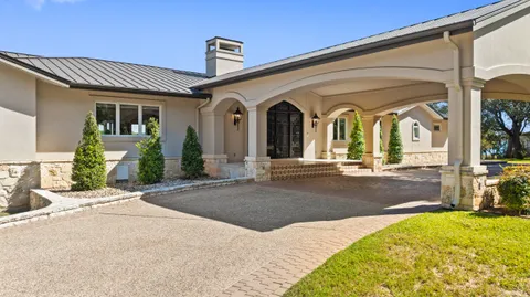 a kitchen with stainless steel appliances granite countertop a refrigerator a stove and a sink with cabinets