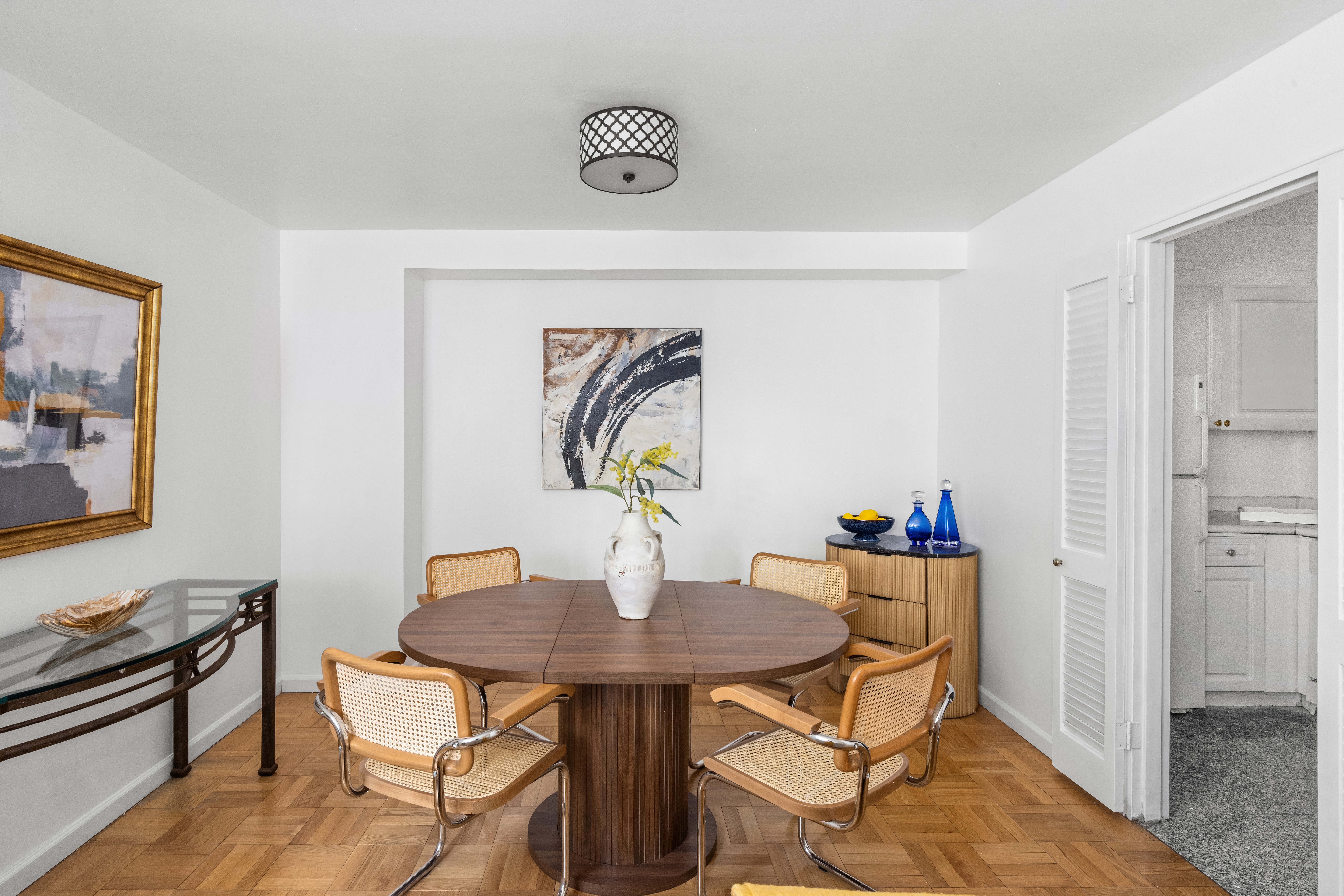 200 East 58th Street, Unit 6B Manhattan, NY 10022 - Photo 6 of 12 a view of a dining room with furniture and wooden floor