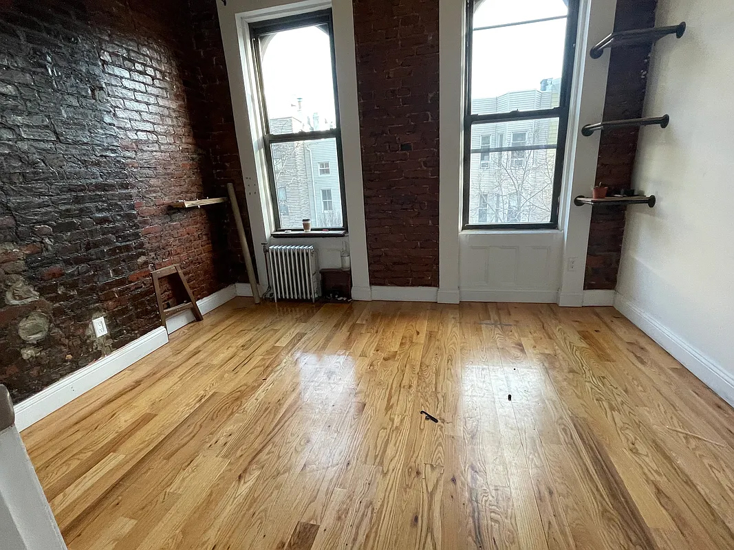 199 Java Street Brooklyn, NY 11222 - Photo 30 of 32 an empty room with wooden floor and windows