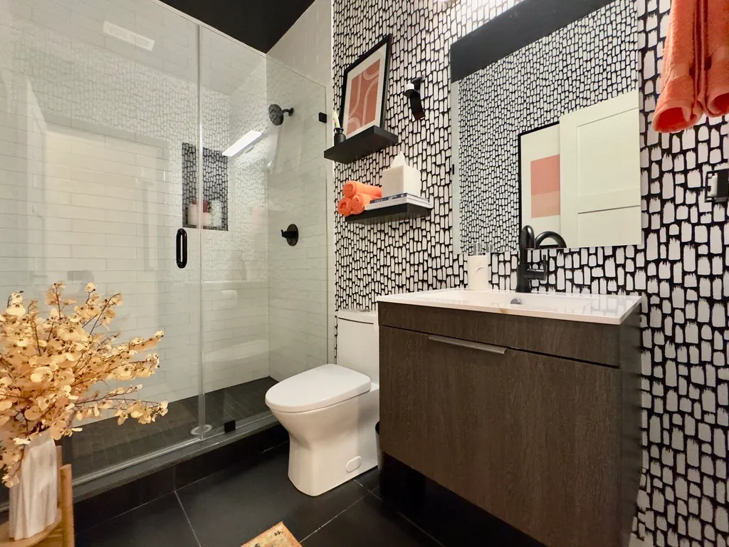 a bathroom with a sink toilet and shower