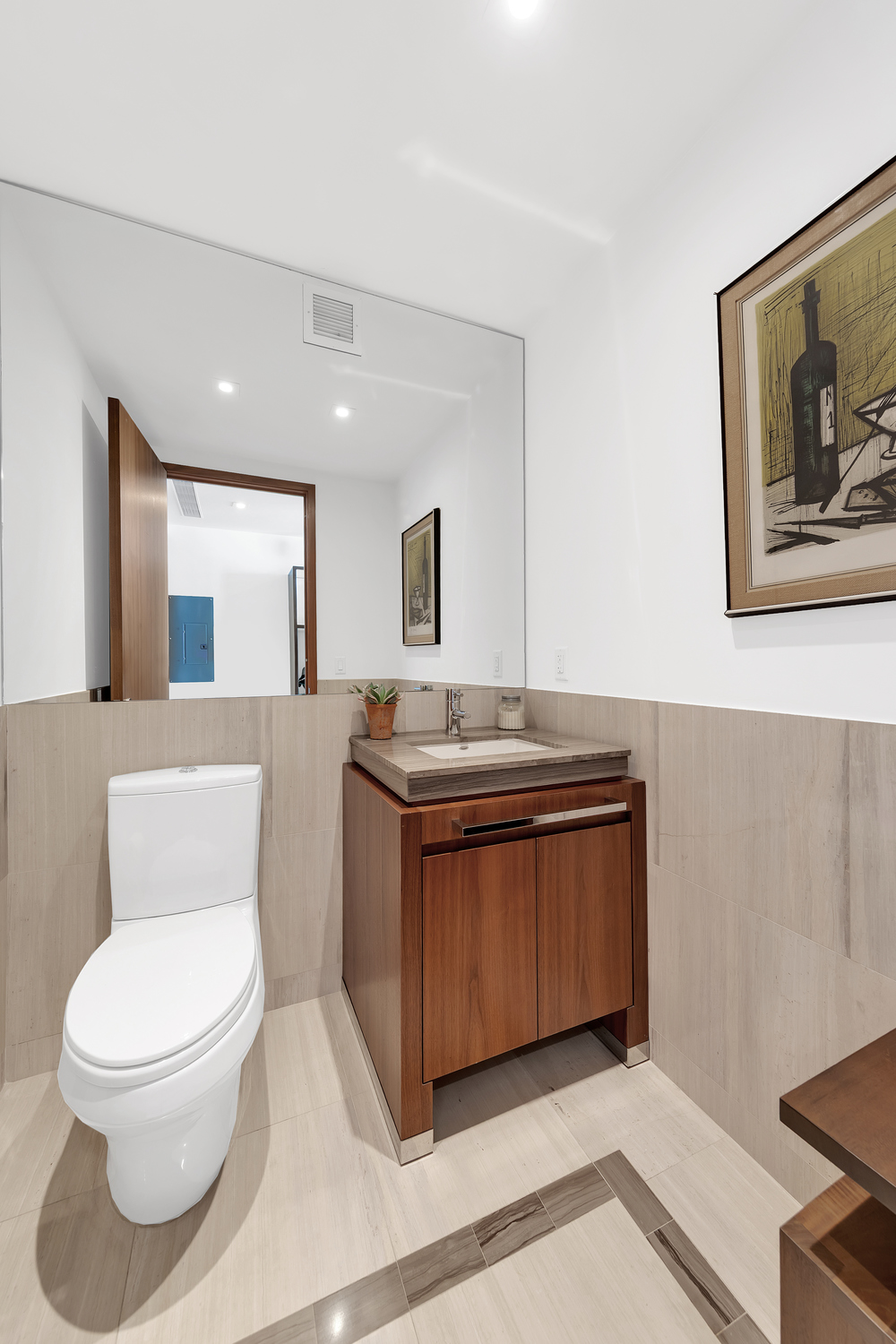 400 5th Avenue, Unit 33B Manhattan, NY 10018 - Photo 4 of 11 a spacious bathroom with a granite countertop toilet sink and mirror