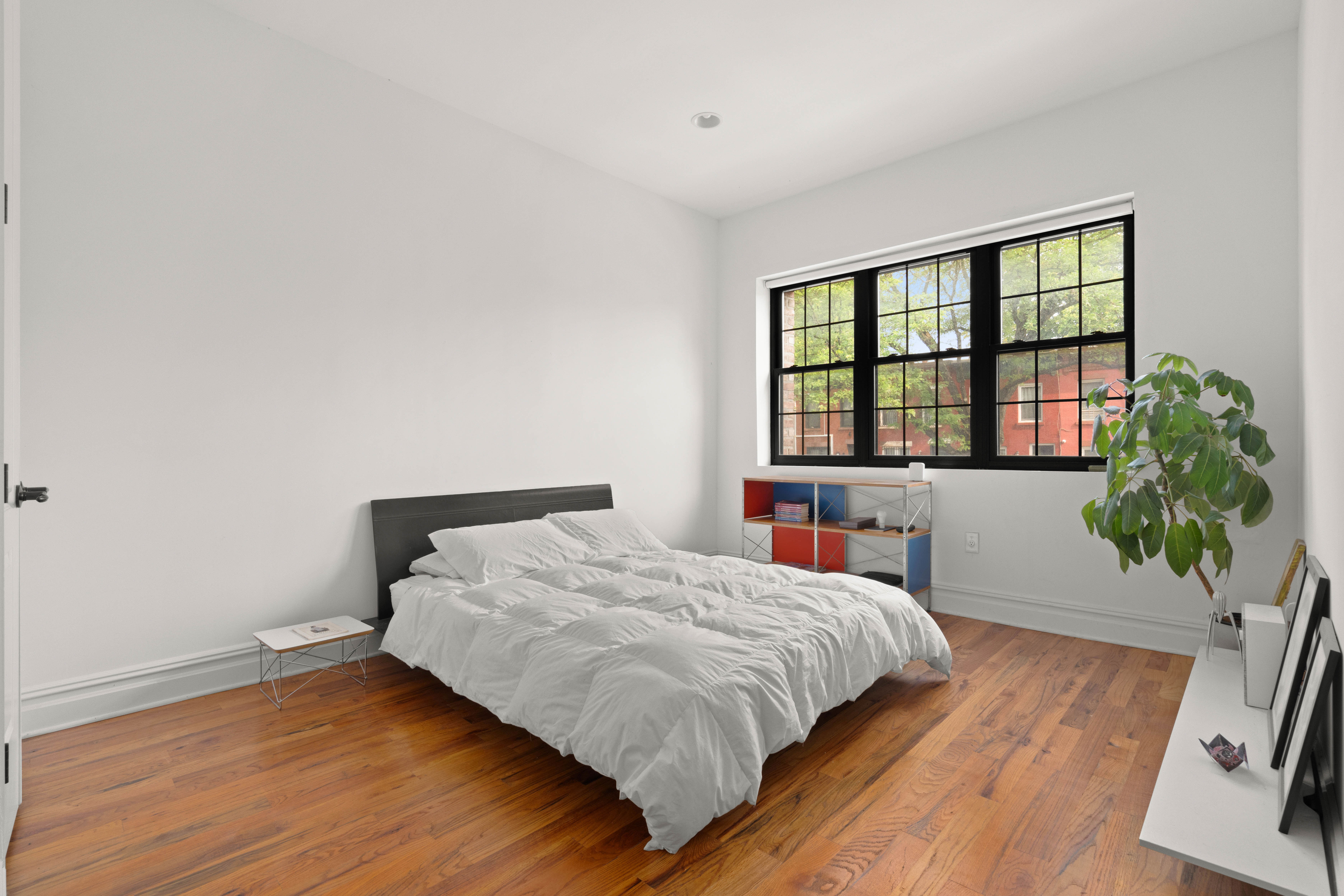 748 Madison Street, Unit 1 Brooklyn, NY 11221 - Photo 4 of 10 a bedroom with a bed and a large window