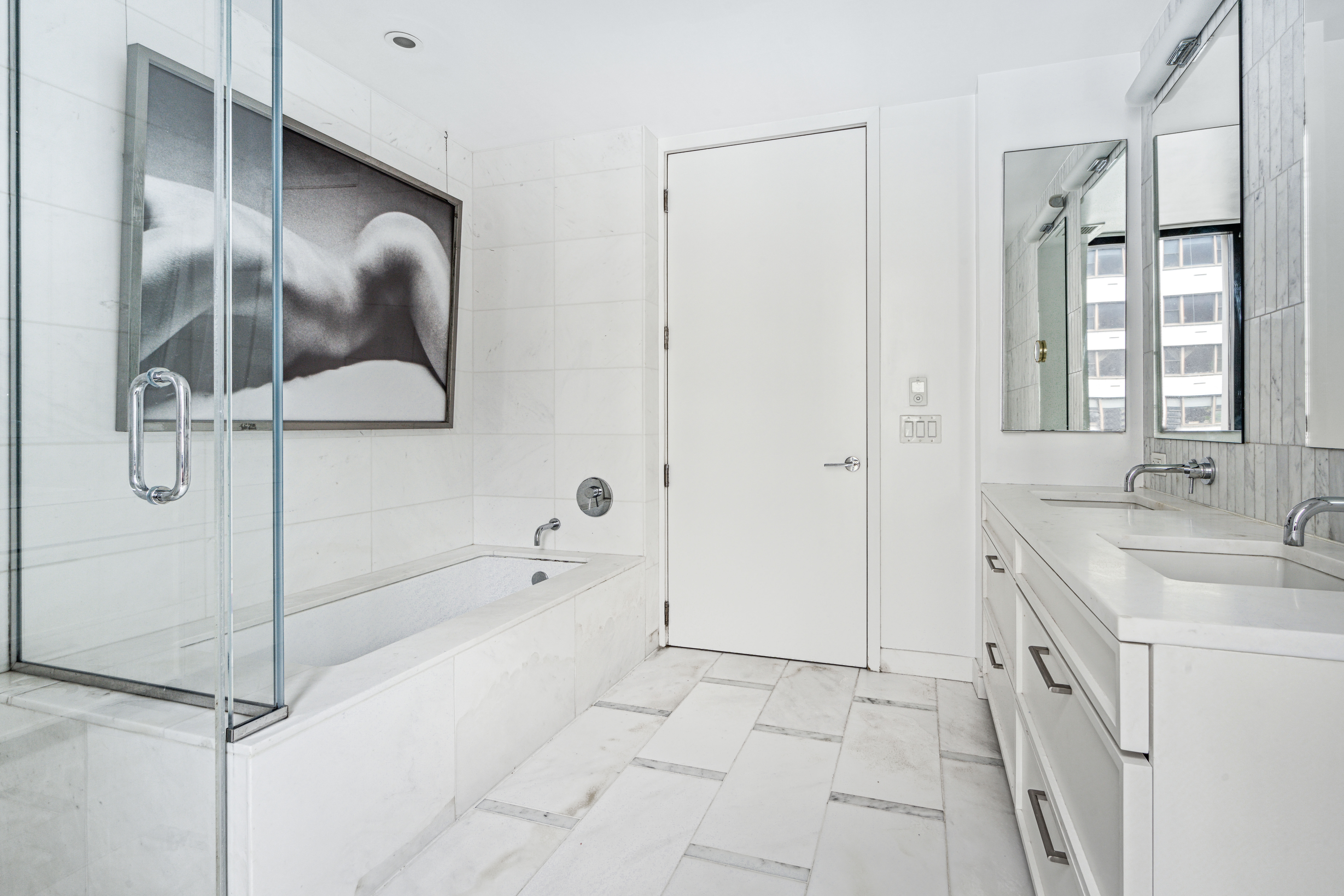 160 East 22nd Street, Unit 9E Manhattan, NY 10010 - Photo 8 of 17 a spacious bathroom with a granite countertop sink a mirror and shower