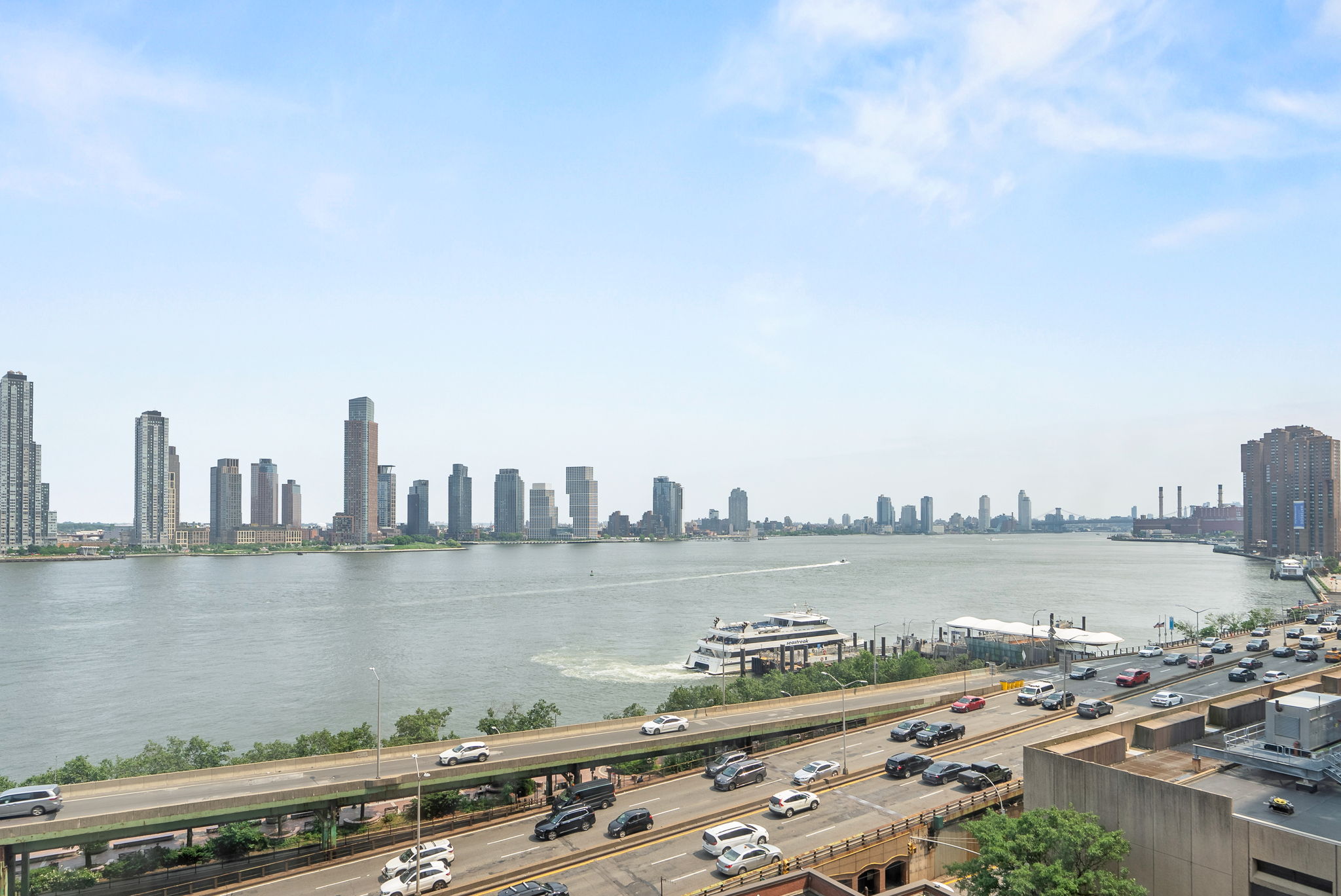 415 East 37th Street, Unit 9D Manhattan, NY 10016 - Photo 2 of 6 a view of a city with a lake bridge and tall buildings in the background