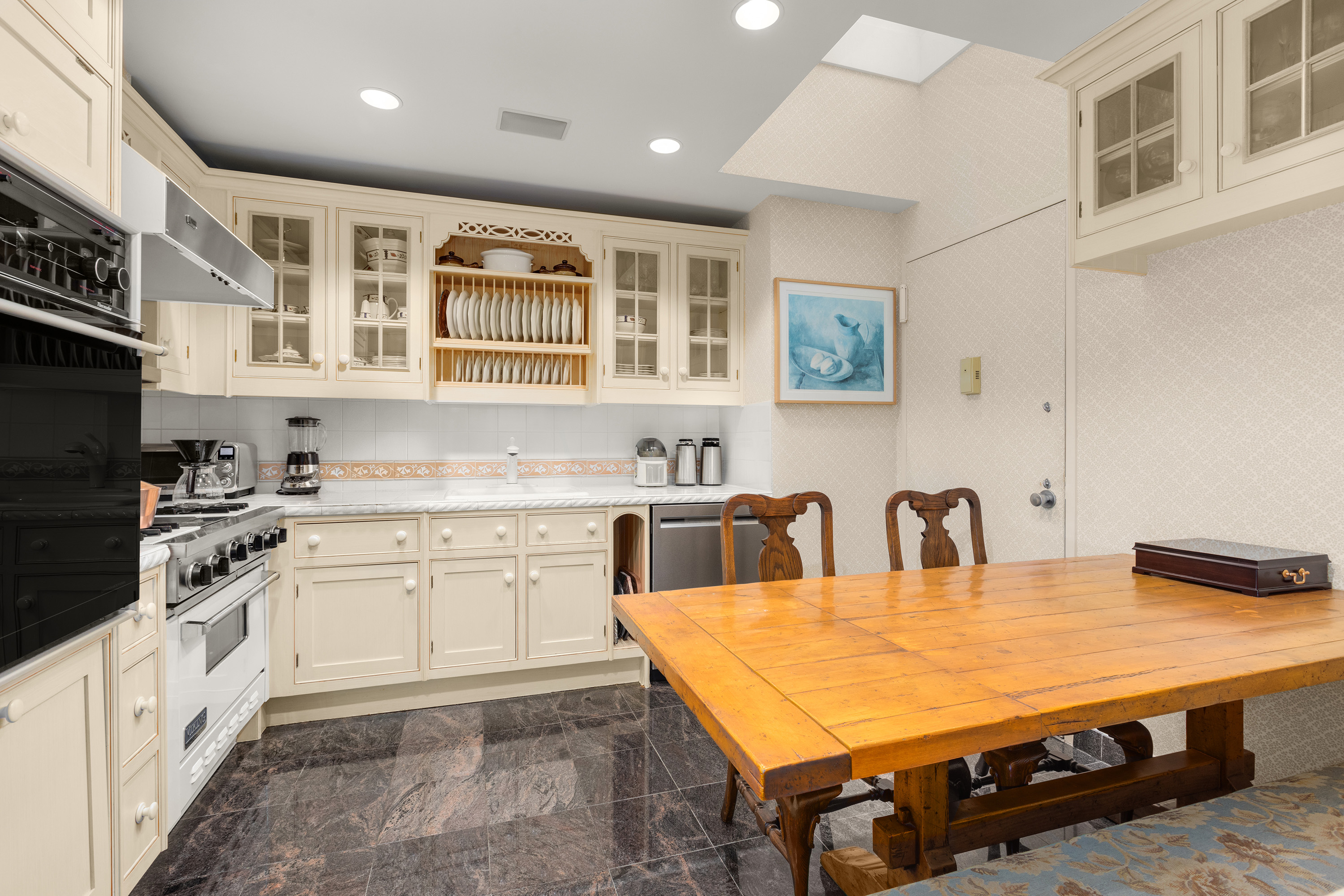 2 East End Avenue, Unit PHG Manhattan, NY 10075 - Photo 6 of 15 a kitchen with stainless steel appliances granite countertop a stove a sink dishwasher and microwave with wooden floor
