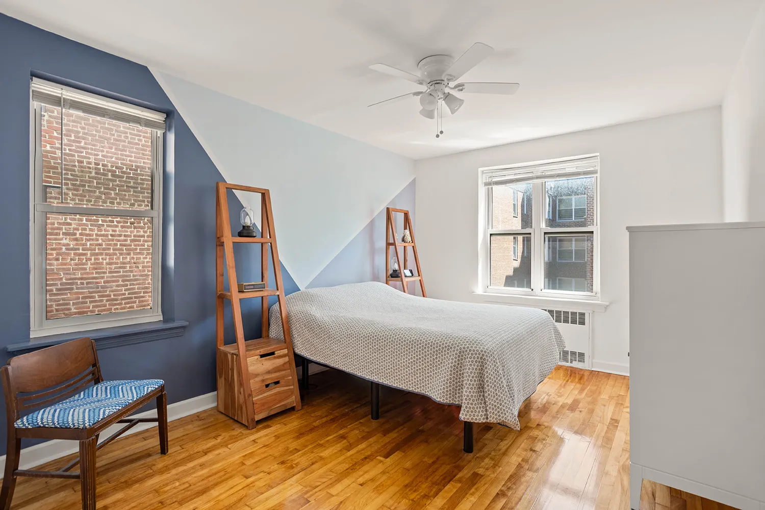 a bedroom with a bed a chandelier and a window