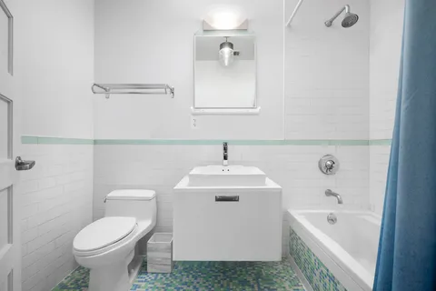 a bathroom with a sink toilet and bathtub