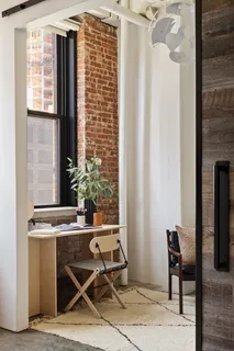 a bedroom with furniture and a window