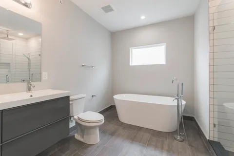 a bathroom with a toilet a sink and a bathtub