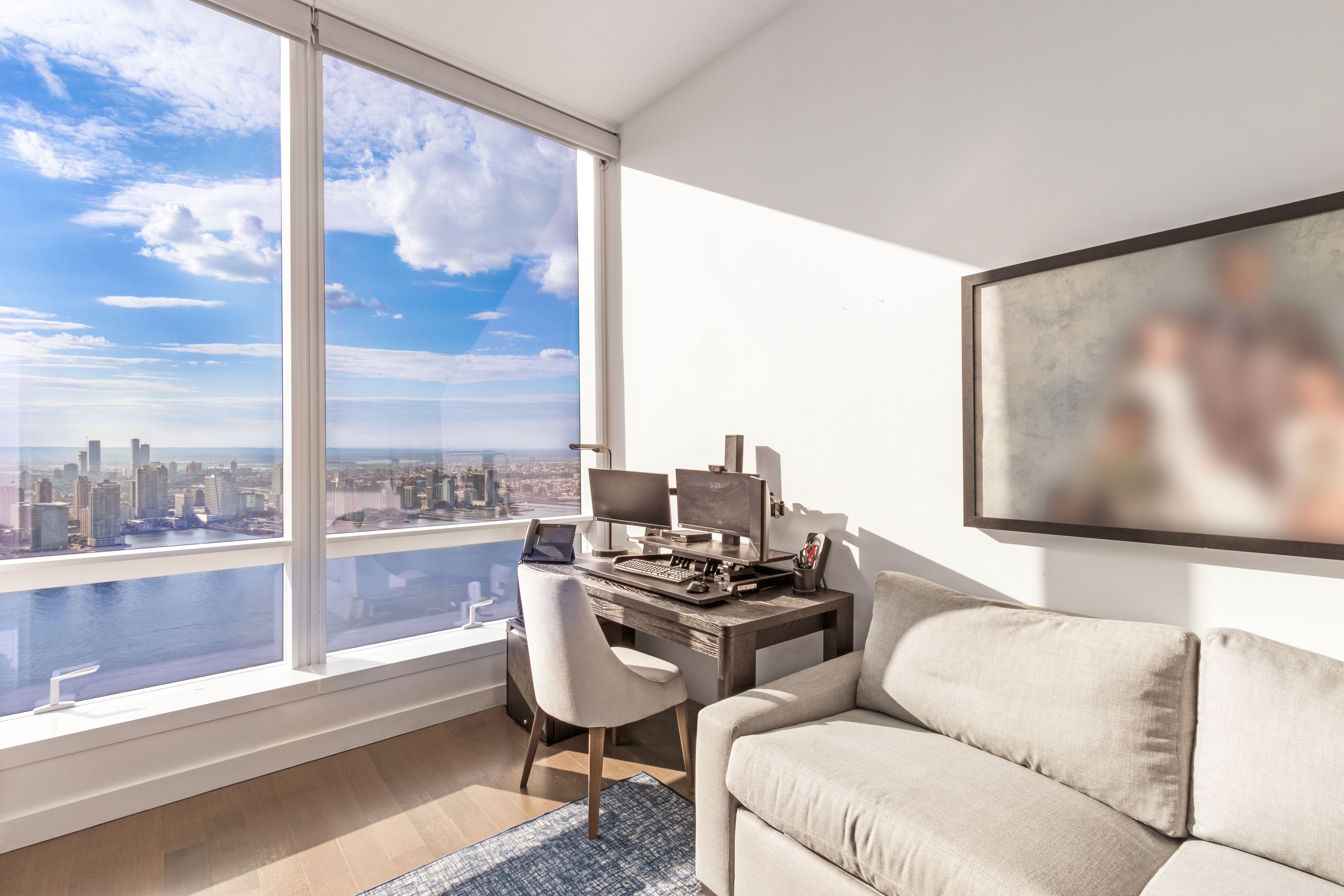 111 Murray Street, Unit 61W Manhattan, NY 10007 - Photo 21 of 35 a living room with furniture and a flat screen tv
