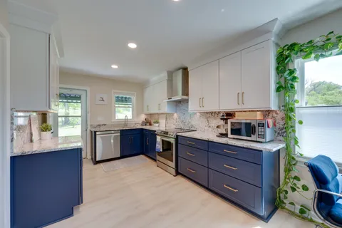 a kitchen with stainless steel appliances granite countertop a refrigerator and a sink