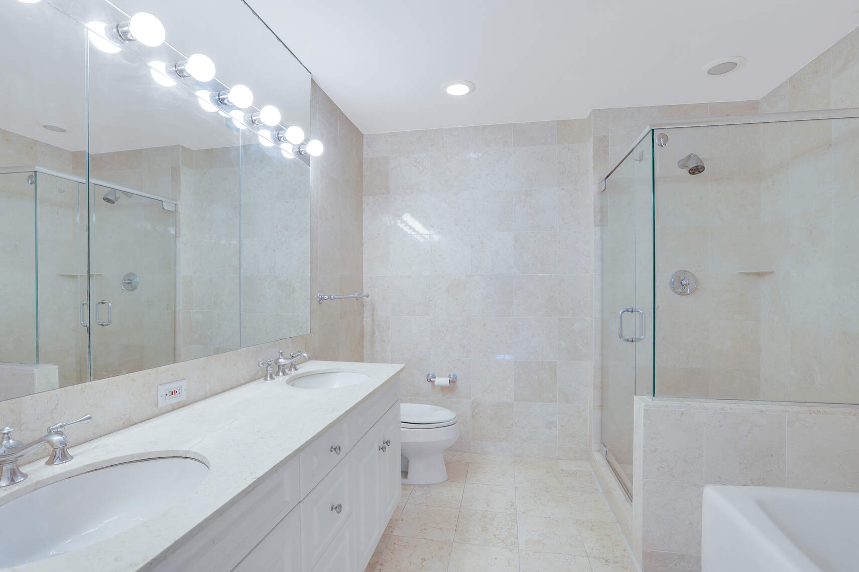 2 Columbus Avenue, Unit 17C Manhattan, NY 10023 - Photo 7 of 26 a bathroom with a double vanity sink mirror and toilet