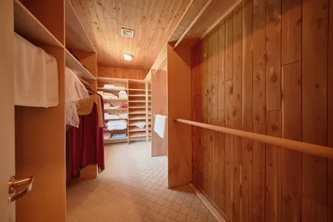 a bedroom with a large bed and a couch