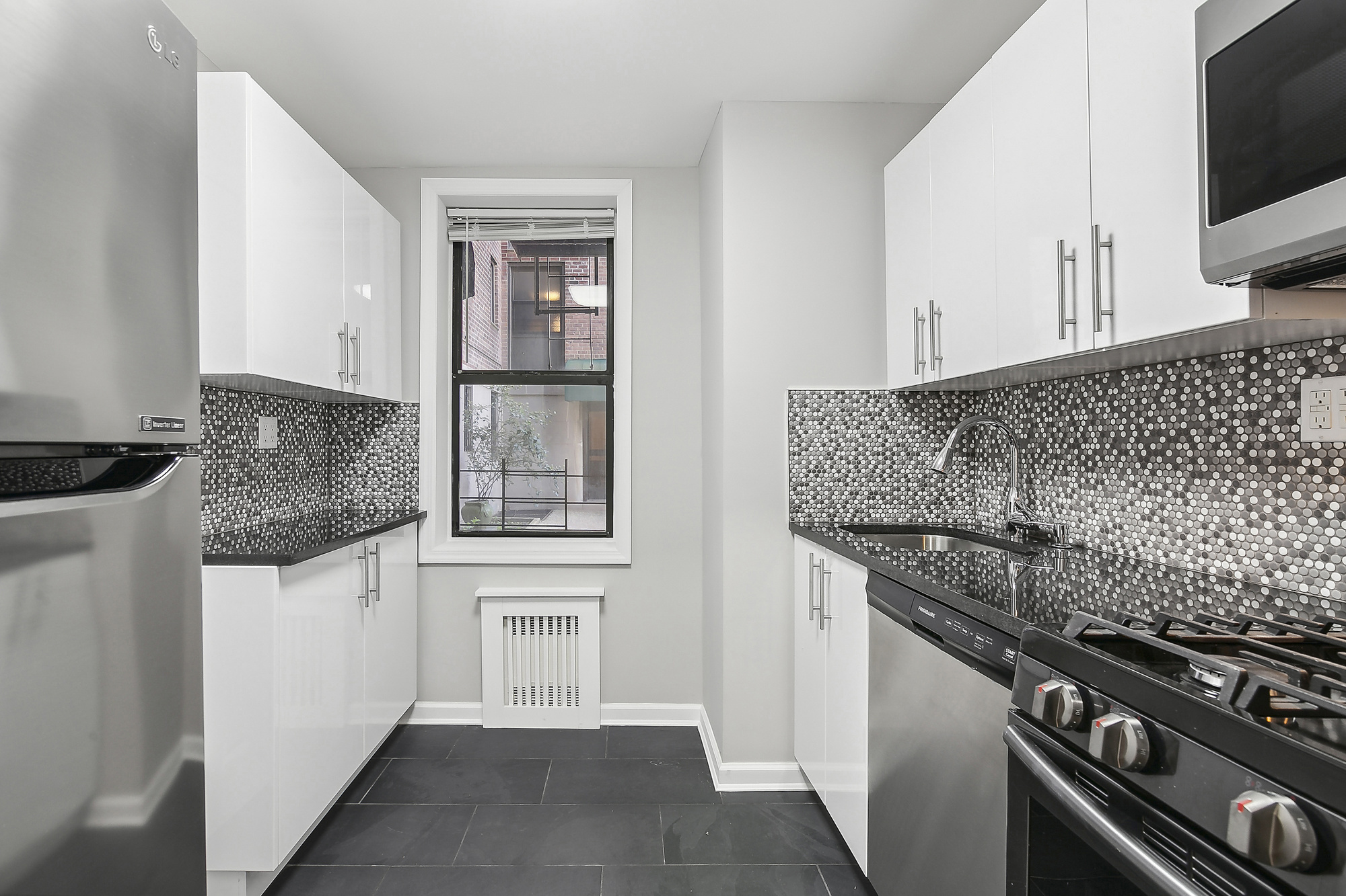 40 89th Street, Unit 1F Brooklyn, NY 11209 - Photo 5 of 13 a kitchen with a stove and a microwave