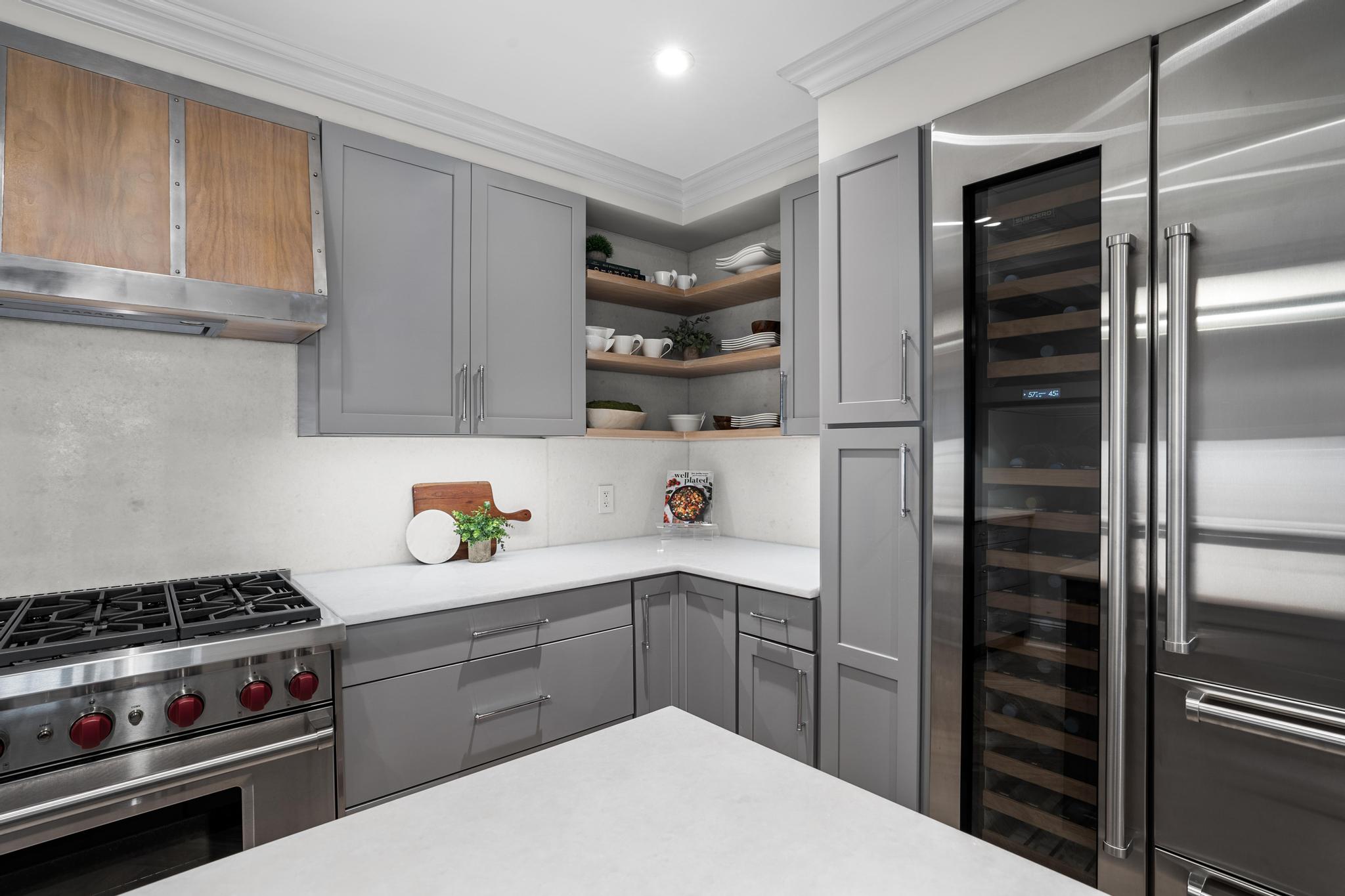 110 East 57th Street, Unit 10CD Manhattan, NY 10022 - Photo 6 of 16 a kitchen with a refrigerator and a stove top oven