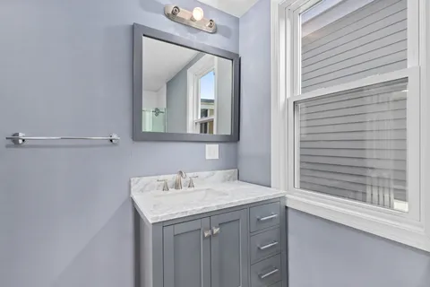 a bathroom with a sink and a mirror