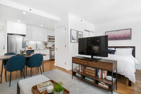 a bedroom with furniture and a flat screen tv