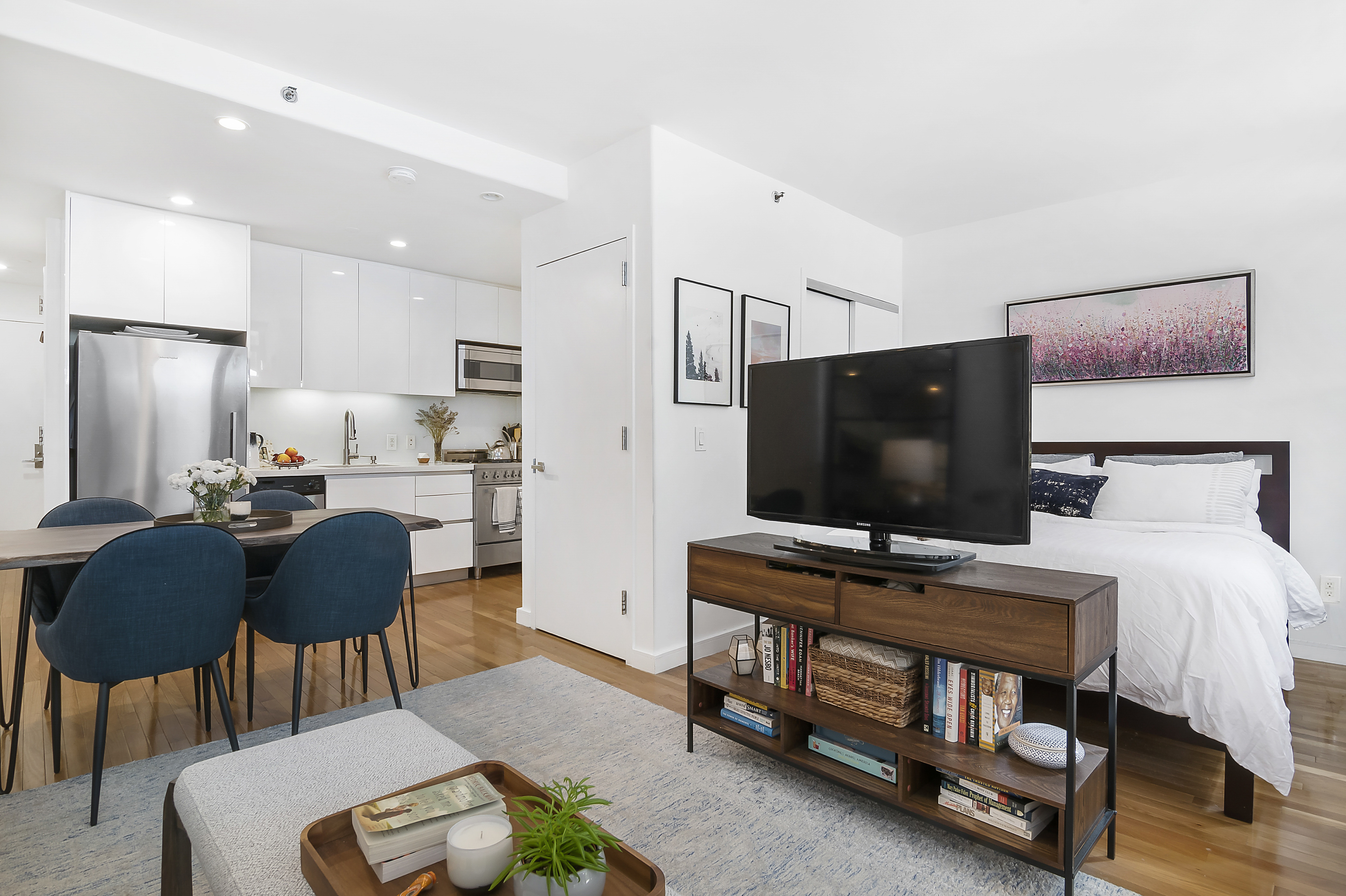 148 East 24th Street, Unit 3F Manhattan, NY 10010 - Photo 5 of 9 a bedroom with furniture and a flat screen tv