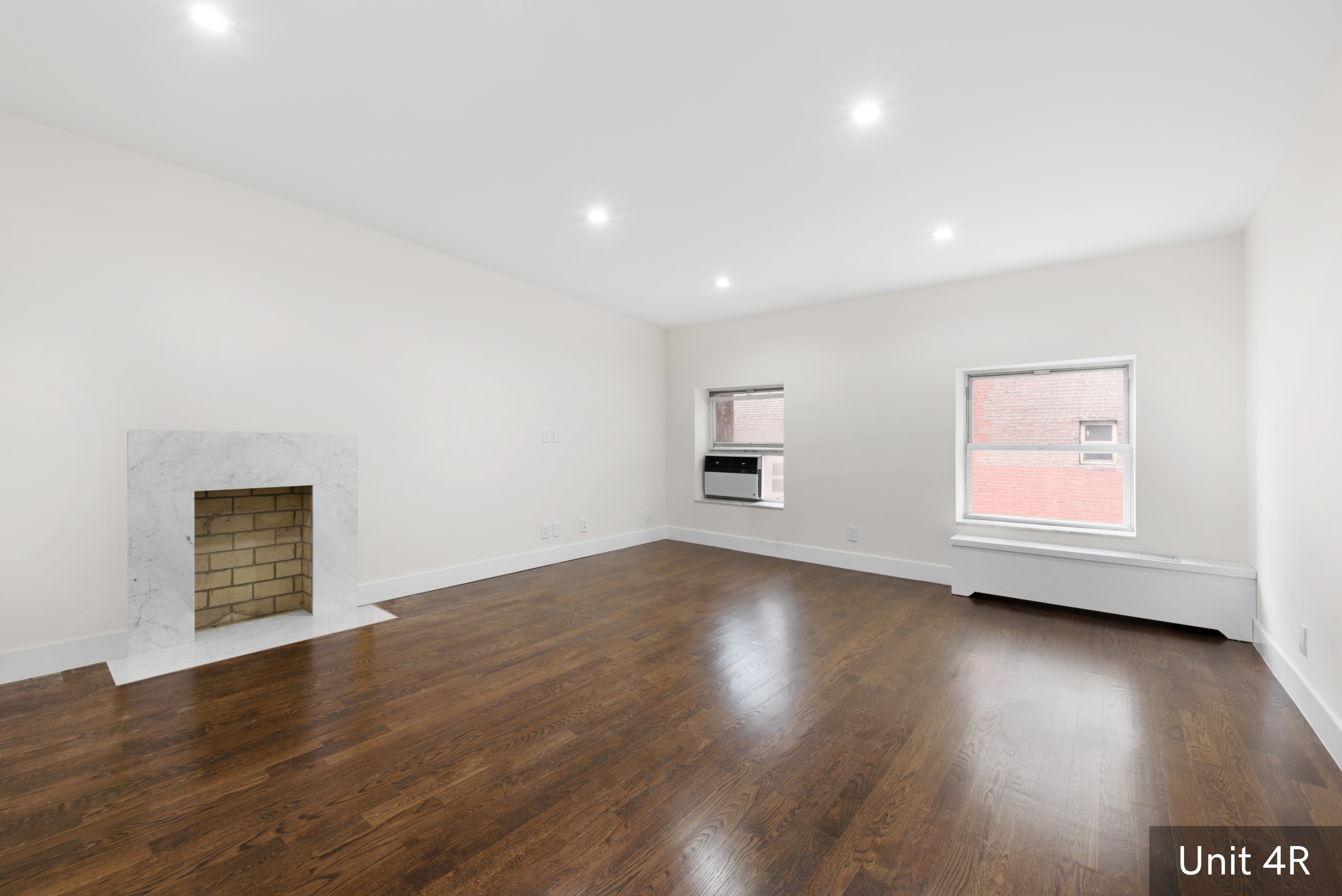 120 East 19th Street Manhattan, NY 10003 - Photo 25 of 33 a view of an empty room with a window and wooden floor