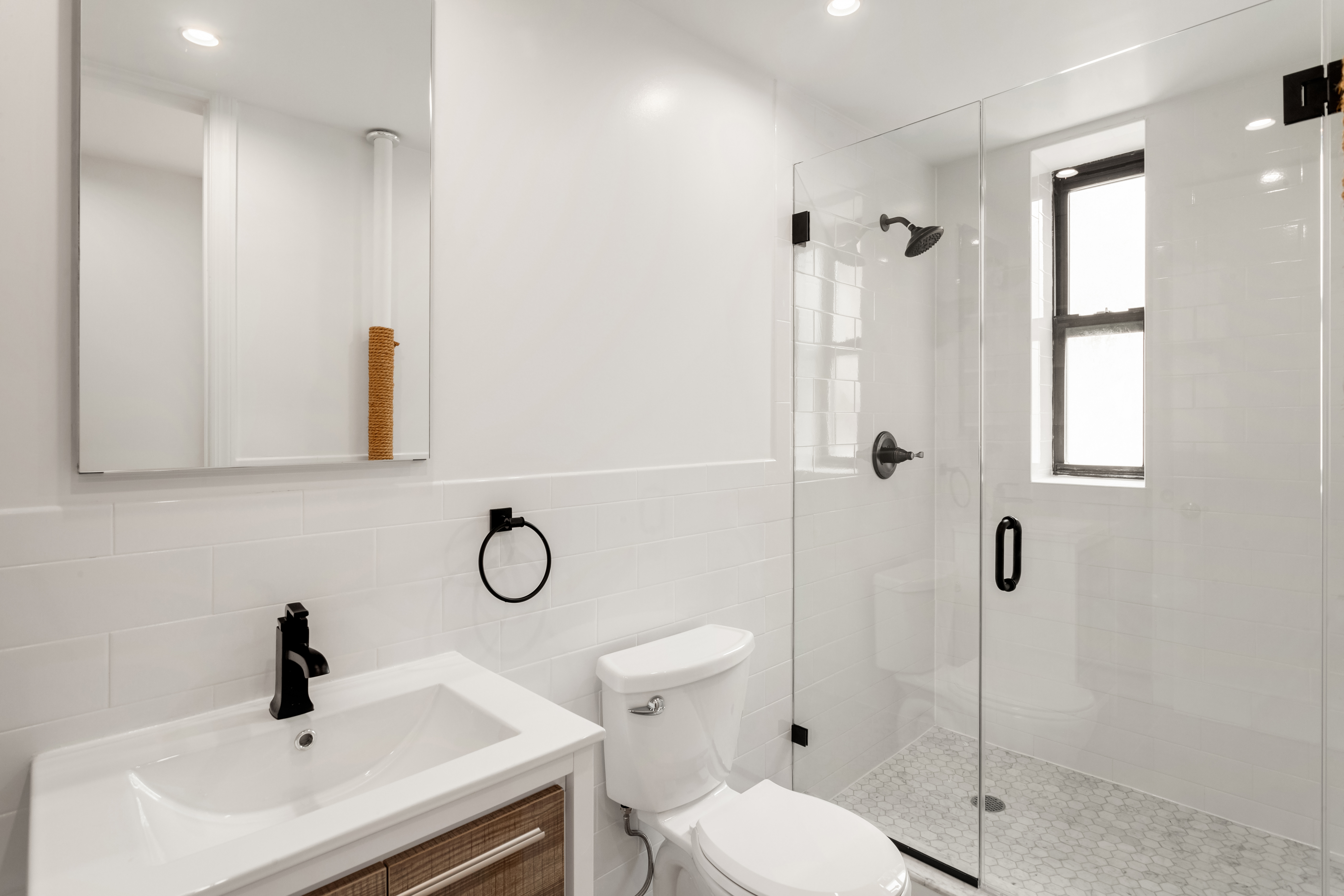 305 West 18th Street, Unit 4C Manhattan, NY 10011 - Photo 4 of 7 a bathroom with a toilet sink and shower